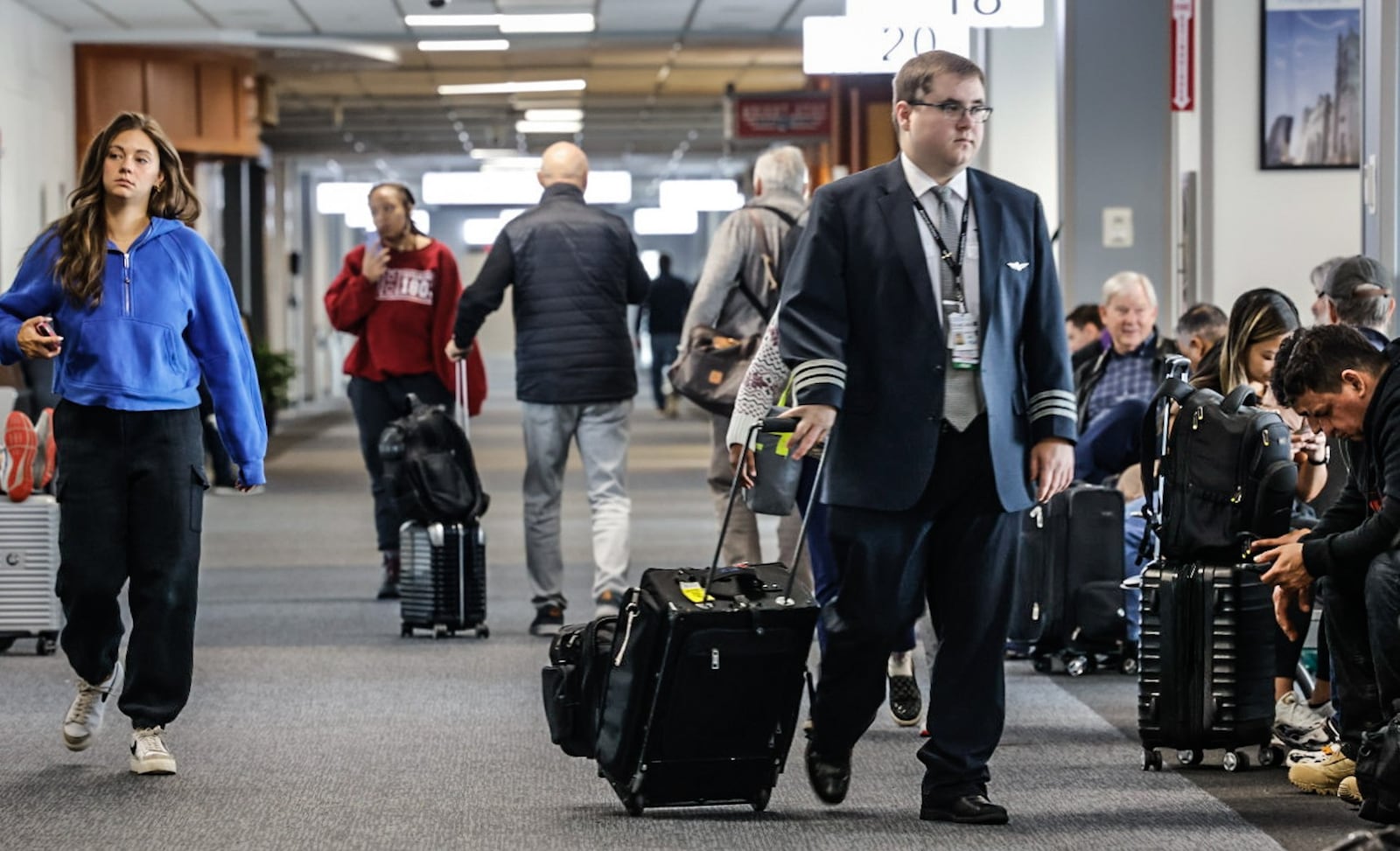 Travelers make their way through Dayton International Airport terminal Friday, Nov. 22, 2024. AAA projects 4.9 million Ohioans will travel over the 10-day year-end holiday travel period, a 2.9% increase over 2023 that surpassed a pre-pandemic number of 4.8 million and sets a new record. JIM NOELKER/STAFF