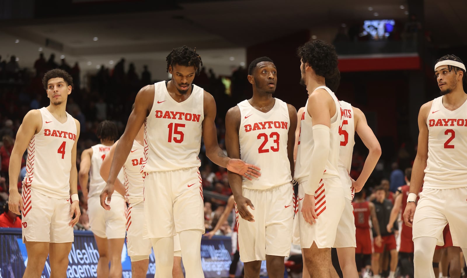 Dayton players return to the court after a huddle against Saint Joseph’s on Wednesday, Jan. 4, 2023, at UD Arena. David Jablonski/Staff