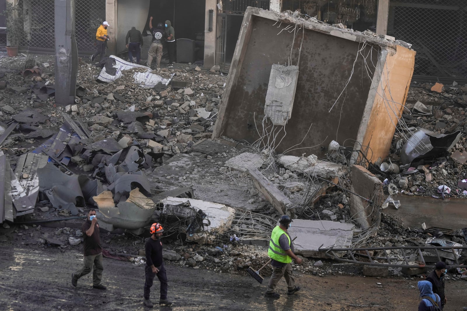 Rescuers check a building hit by an Israeli airstrike in Chiyah, the southern suburb of Beirut, Lebanon, Friday, Nov. 22, 2024. (AP Photo/Bilal Hussein)