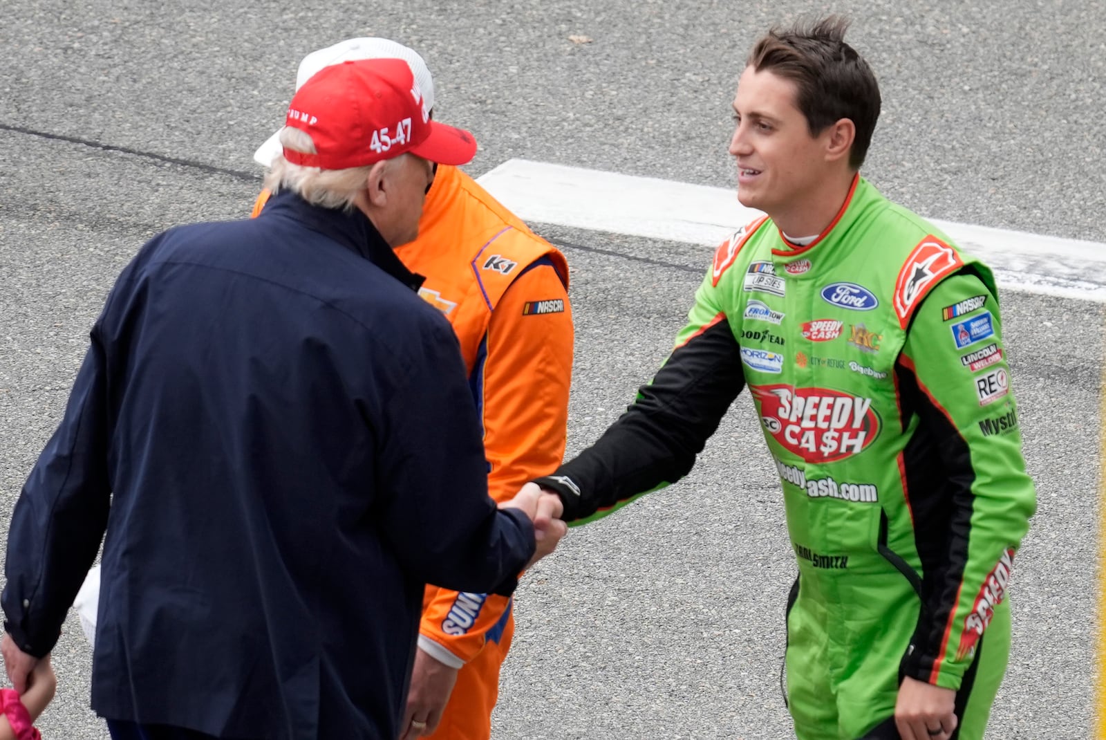 President Donald Trump, left, greets Zane Smith at the NASCAR Daytona 500 auto race at Daytona International Speedway, Sunday, Feb. 16, 2025, in Daytona Beach, Fla. (AP Photo/Chris O'Meara)