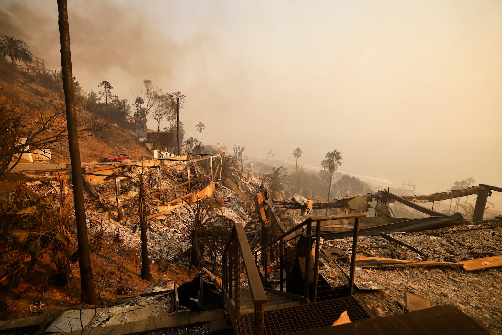 Homes damaged by the Palisades Fire are seen along the beach, Wednesday, Jan. 8, 2025, in Malibu, Calif. (AP Photo/Etienne Laurent)