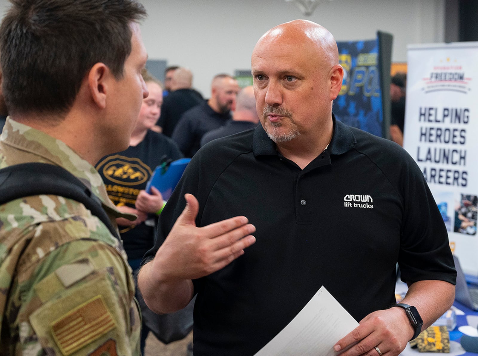 Brian Case, representing Crown Lift Trucks, talks with Maj. Rich Dill, Air Force Institute of Technology, about career opportunities during the Hiring Our Heroes event June 22 at Hope Hotel near Wright-Patterson Air Force Base. Crown, part of the material-handling industry, was looking for Airmen about to separate or recently separated from the service to fill positions with the company. U.S. AIR FORCE PHOTO/R.J. ORIEZ