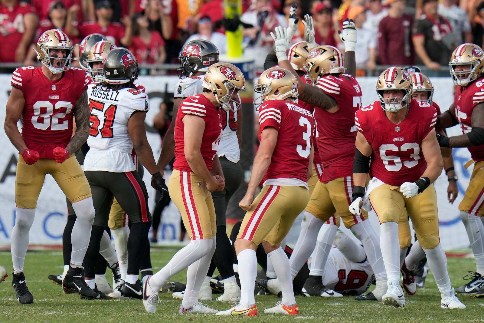 San Francisco 49ers place kicker Jake Moody, middle left, celebrates with Mitch Wishnowsky (3) and teammates after kicking the game winning field goal during the second half of an NFL football game against the Tampa Bay Buccaneers in Tampa, Fla., Sunday, Nov. 10, 2024. (AP Photo/Chris O'Meara)