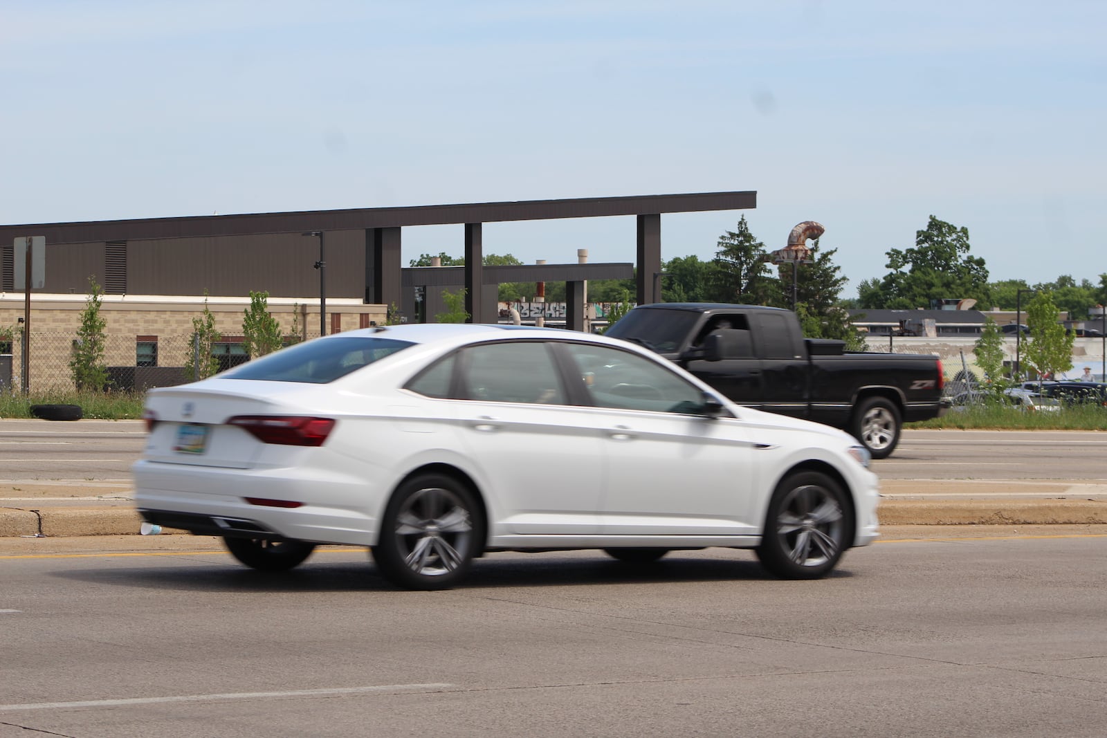 Two vehicles on U.S. 35 drive by the Dayton Metro Library's West Branch Library, which opened earlier this year. CORNELIUS FROLIK / STAFF