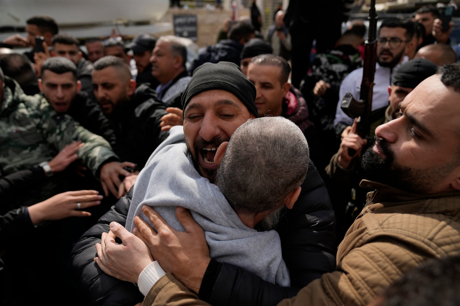 Palestinian prisoners are greeted as they exit a Red Cross bus after being released from Israeli prison following a ceasefire agreement between Israel and Hamas, in the West Bank city of Ramallah, Saturday Feb. 1, 2025. (AP Photo/Nasser Nasser)