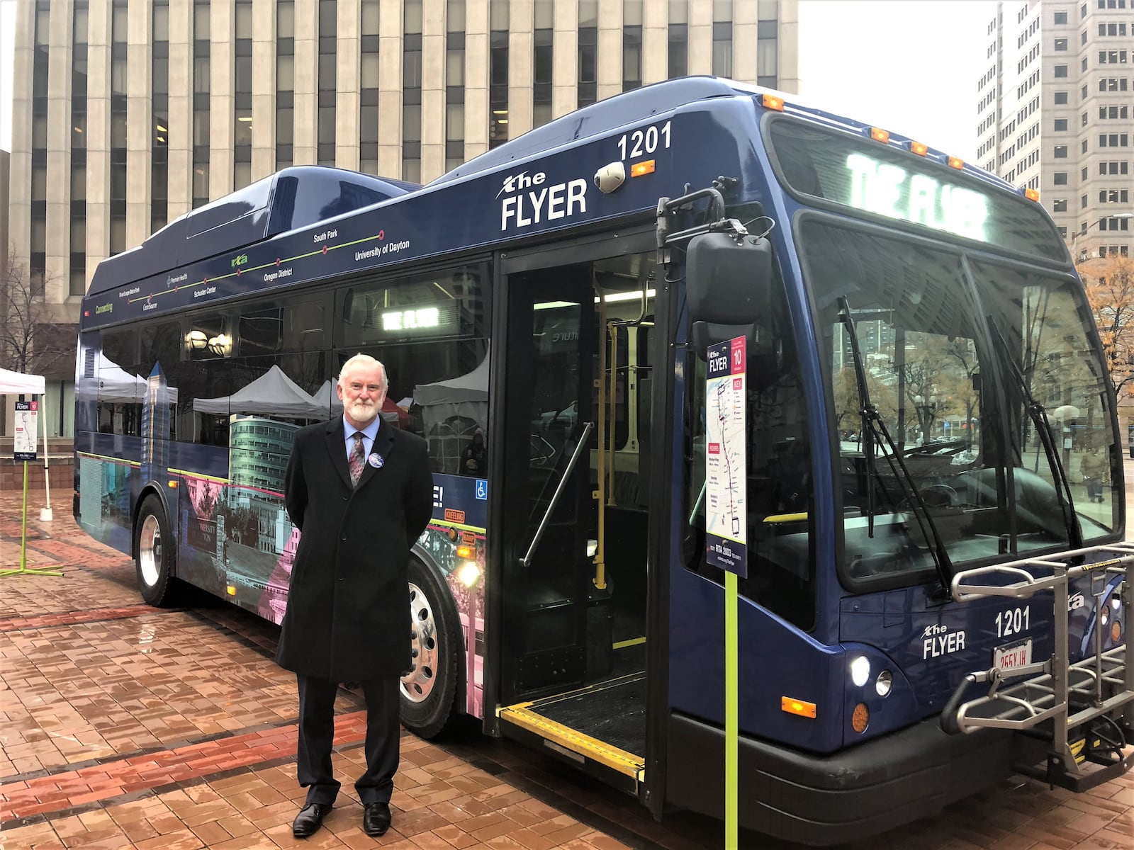 Mark Donaghy, Greater Dayton RTA CEO, stands next to the Flyer, a downtown shuttle bus free for riders. CORNELIUS FROLIK / STAFF