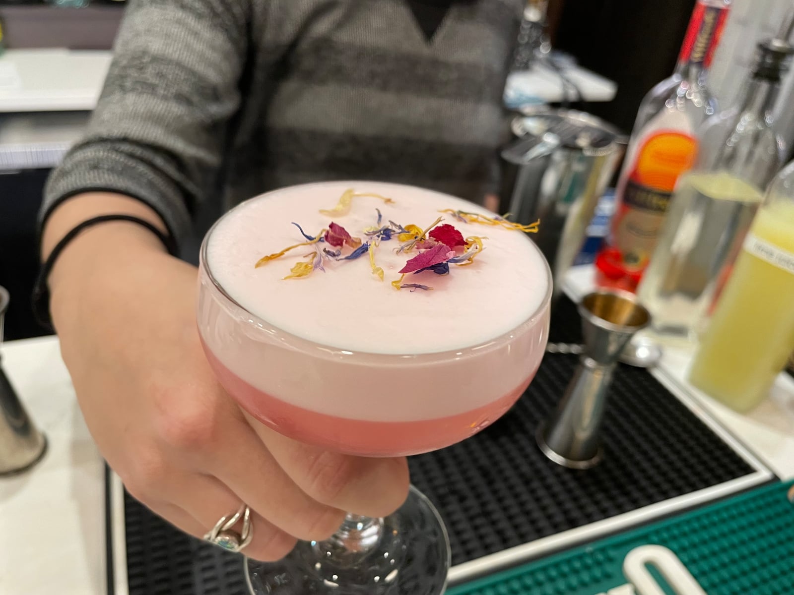 Tori Adams makes a non-alcoholic beverage at Gather by Ghostlight. The Wilfred Sour features Wilfred non-alcoholic aperitif, lime juice, simple syrup and egg whites. NATALIE JONES/STAFF