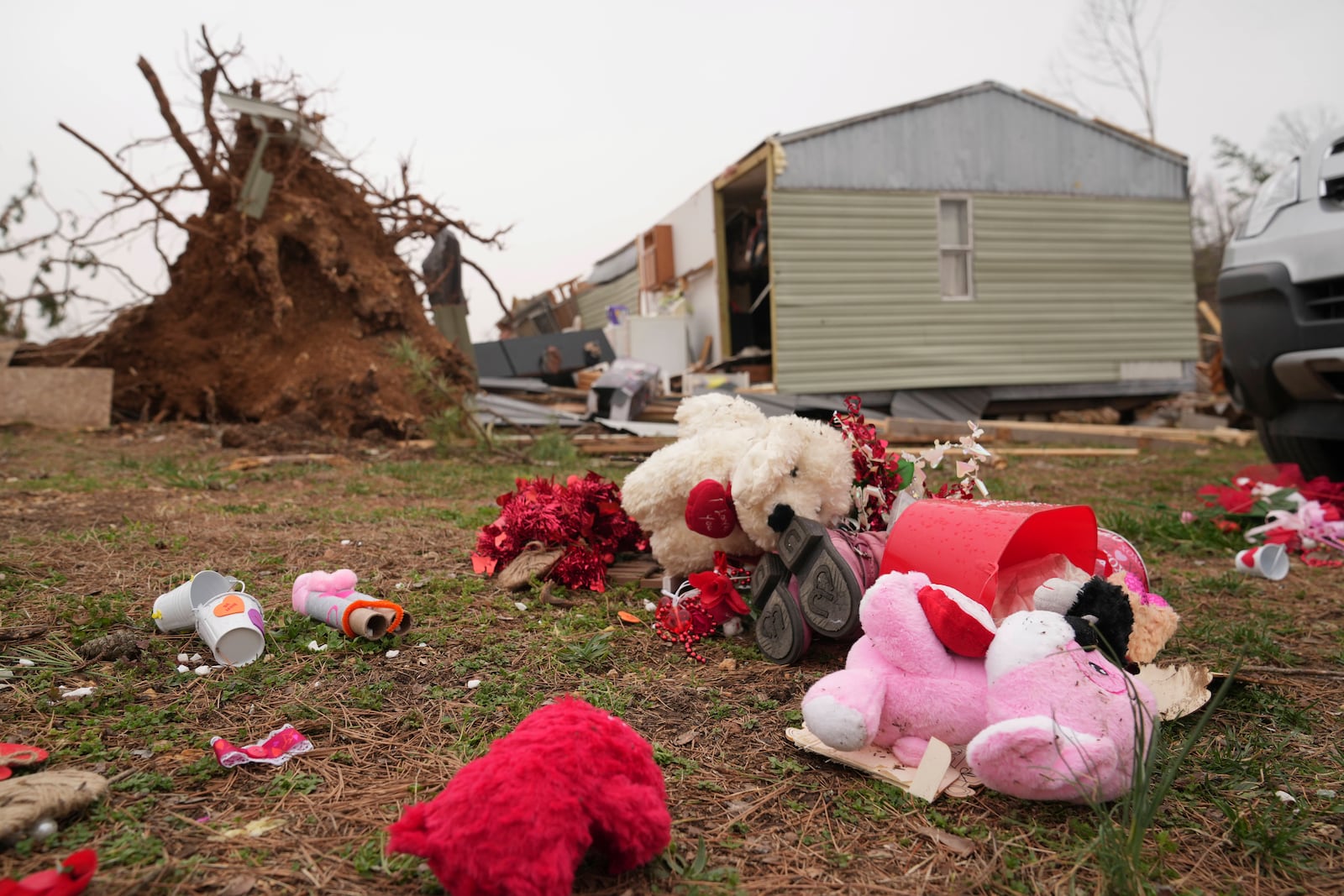 Debris from a severe storm is scattered outside a damaged home Saturday, March 15, 2025, in Wayne County, Mo. (AP Photo/Jeff Roberson)