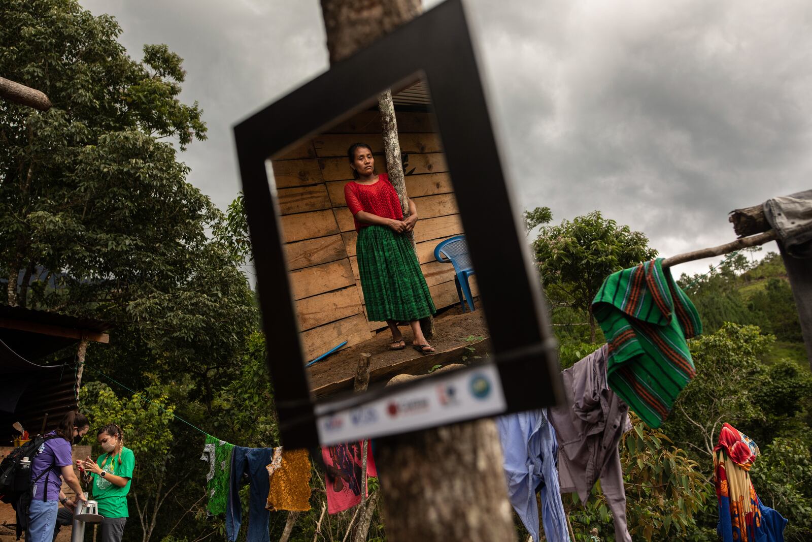 Irma Cal Pop is reflected in a mirror donated by USAID in the makeshift settlement Nuevo Queja, Guatemala, July 12, 2021. USAID donated mirrors to every home in the settlement. (AP Photo/Rodrigo Abd)