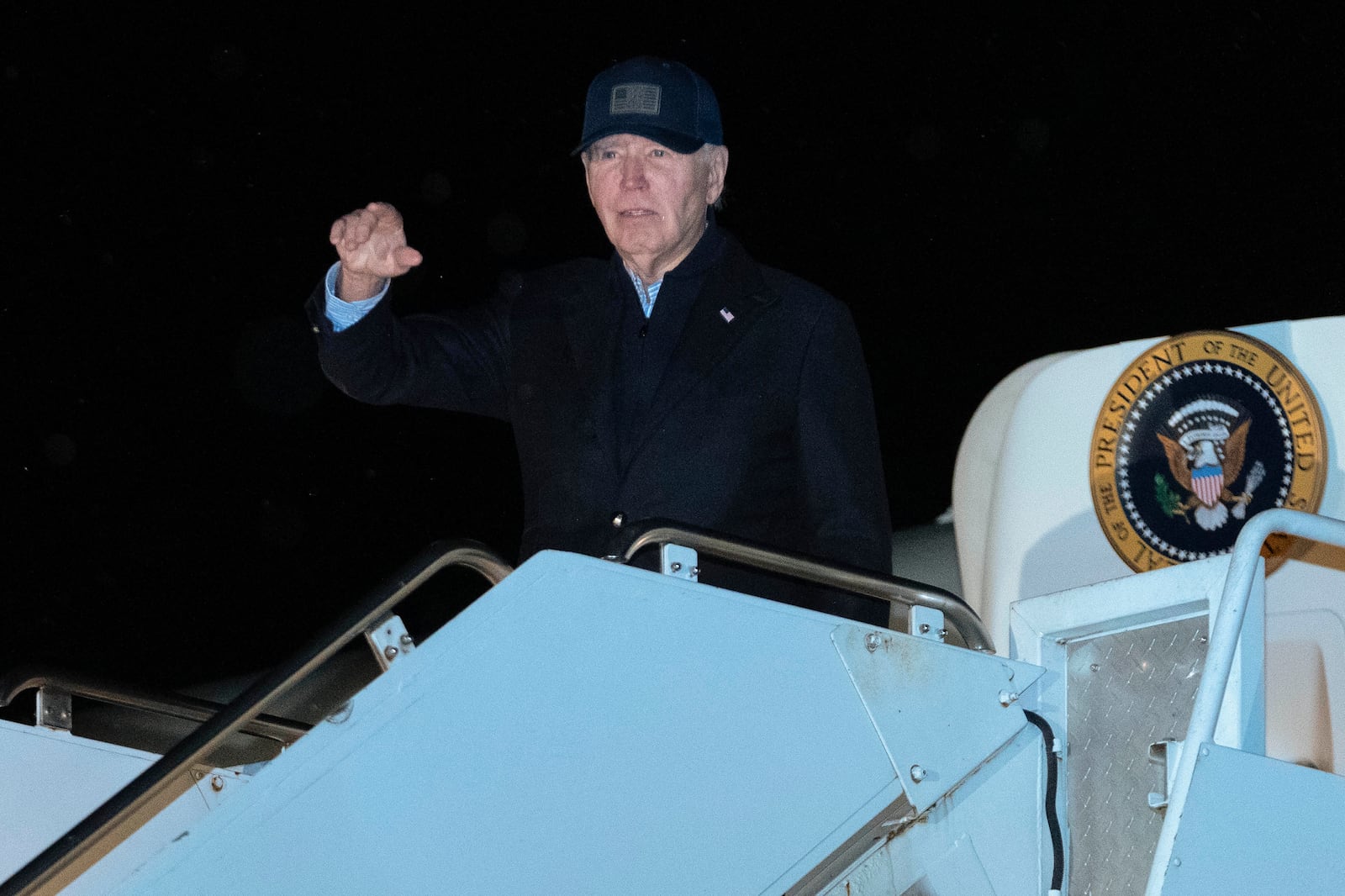 President Joe Biden waves as he boards Air Force One at Nantucket Memorial Airport, Mass., Saturday, Nov. 30, 2024, en route to Washington. (AP Photo/Jose Luis Magana)