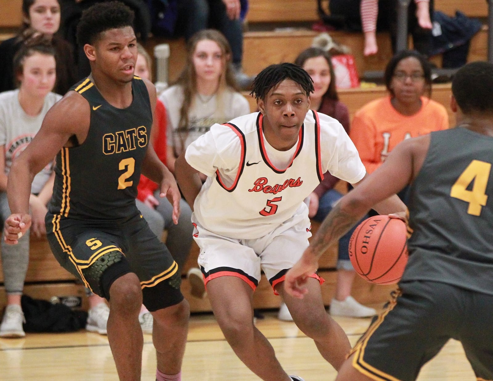 Siloam Baldwin of Beavercreek (with ball) splits Springfield defenders Jalan Minney (left) and Ty Brown. Beavercreek defeated visiting Springfield 54-48 in a GWOC boys high school basketball game on Tuesday, Dec. 17, 2019. MARC PENDLETON / STAFF