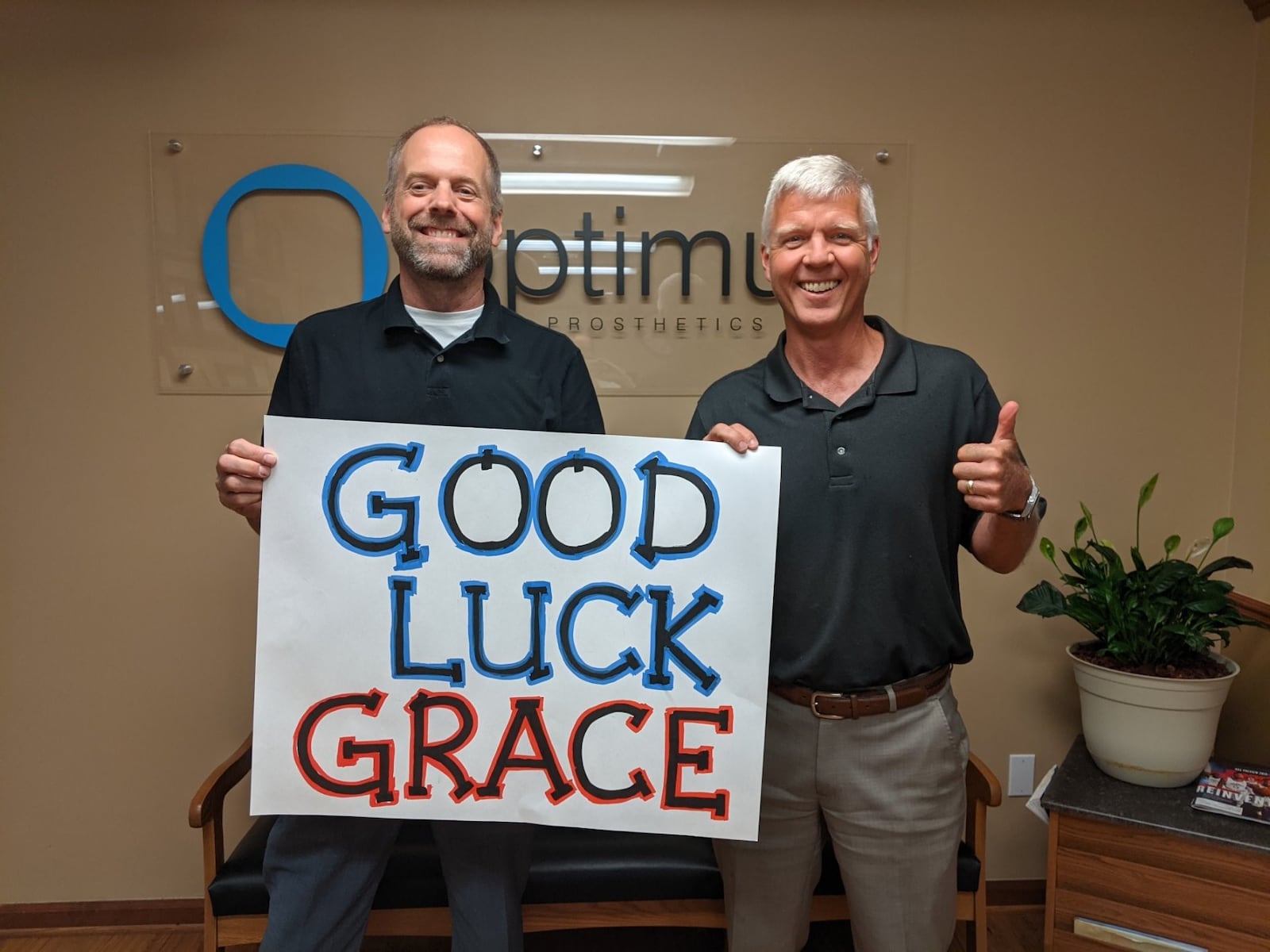 John Brandt (left), founder of Optimus Prosthetics, the Dayton-based company that now has offices in Cincinnati and Columbus, too, and Glenn Schober, the clinical manager and certified prosthetist who handled Grace’s leg needs for many years until he recently left the company, wish Grace good luck in Tokyo. She competes Saturday evening (Dayton time) in the paratriathlon, the event where she won the gold medal at the 2016 Rio de Janeiro Paralympics. CONTRIBUTED