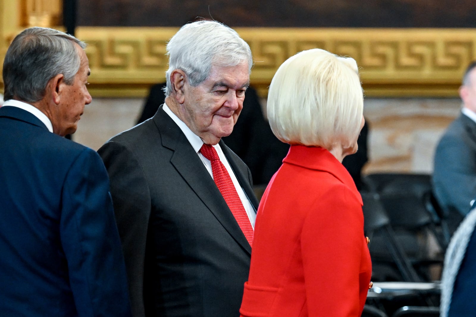 Newt Gingrich, center, his wife Callista Gingrich, right, and former House Speaker John Boehner arrive at the 60th Presidential Inauguration in the Rotunda of the U.S. Capitol in Washington, Monday, Jan. 20, 2025. (Kenny Holston/The New York Times via AP, Pool)