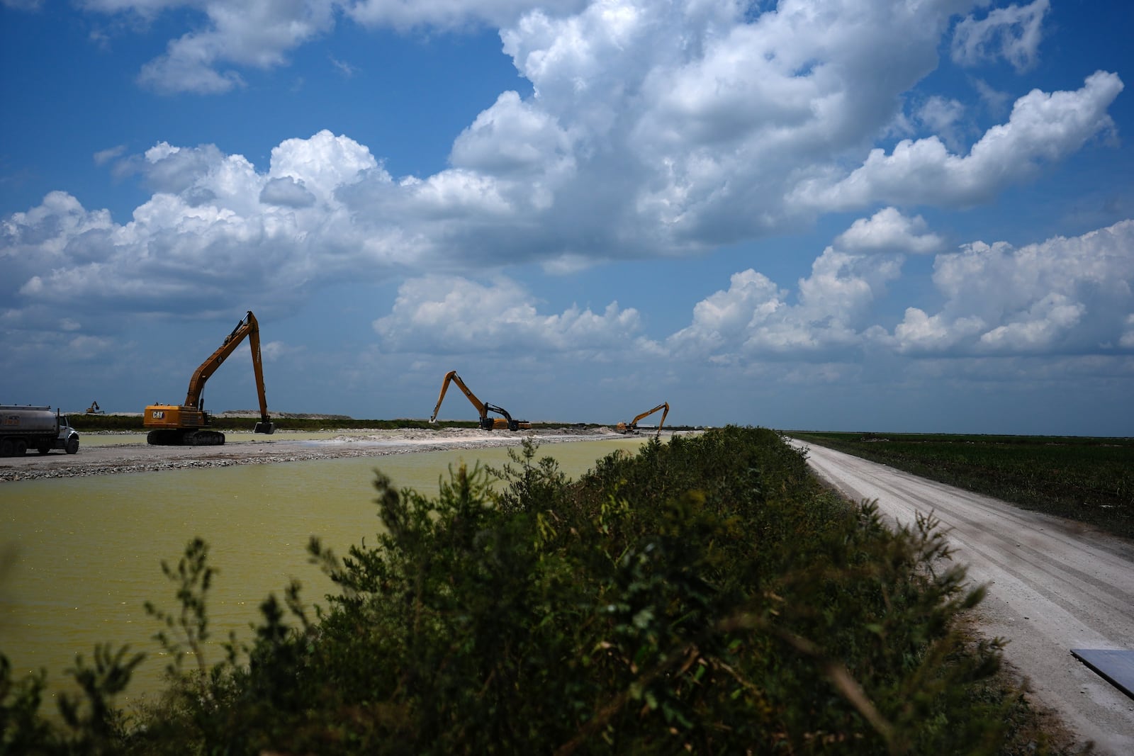 The U.S. Army Corps of Engineers work on the construction of the Everglades Agricultural Area Reservoir, intended to store polluted water from Lake Okeechobee and agricultural runoff so it can be cleaned in an adjacent stormwater treatment area before being released to flow south into the Everglades, Wednesday, May 15, 2024, in South Bay, Fla. (AP Photo/Rebecca Blackwell)