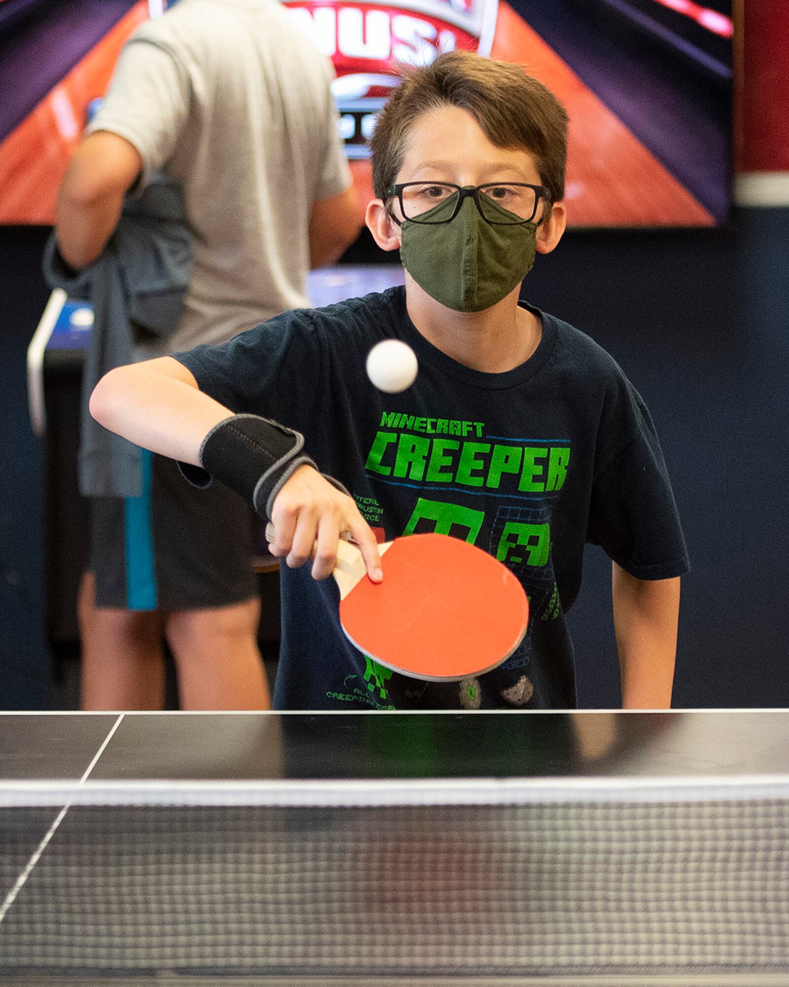 Julian Serna, 12, plays a game of pingpong June 10 in the Prairies Youth Center’s new game room. The 88th Force Support Squadron is opening the room full of free arcade games June 18. U.S. AIR FORCE PHOTO/R.J. ORIEZ