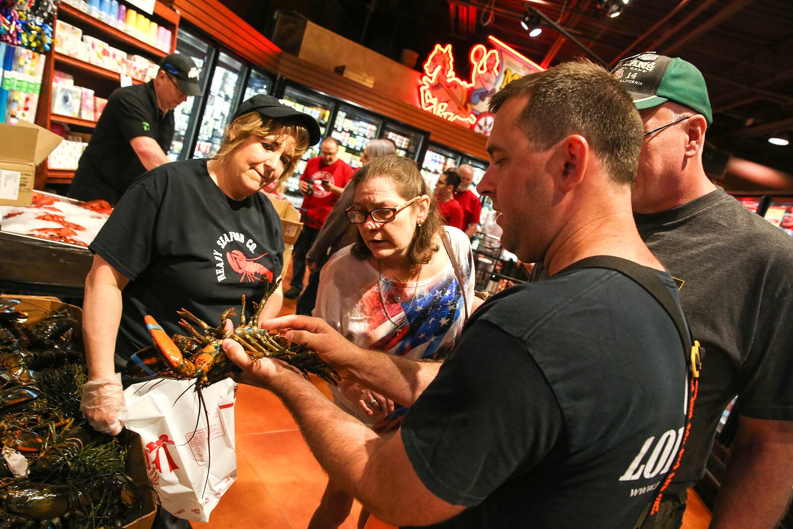 Captain Curt Brown with Ready Seafood, talks with Dorothy Lane Market Customers about lobsters. DOROTHY LANE MARKET