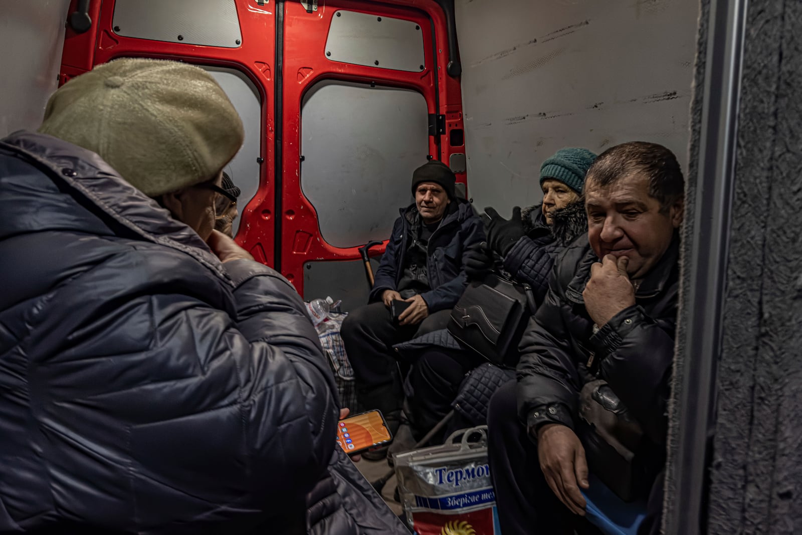 Locals ride inside a van during en evacuation from Kurakhove, Donetsk region, Ukraine, on Nov. 7, 2024. (AP Photo/Anton Shtuka)