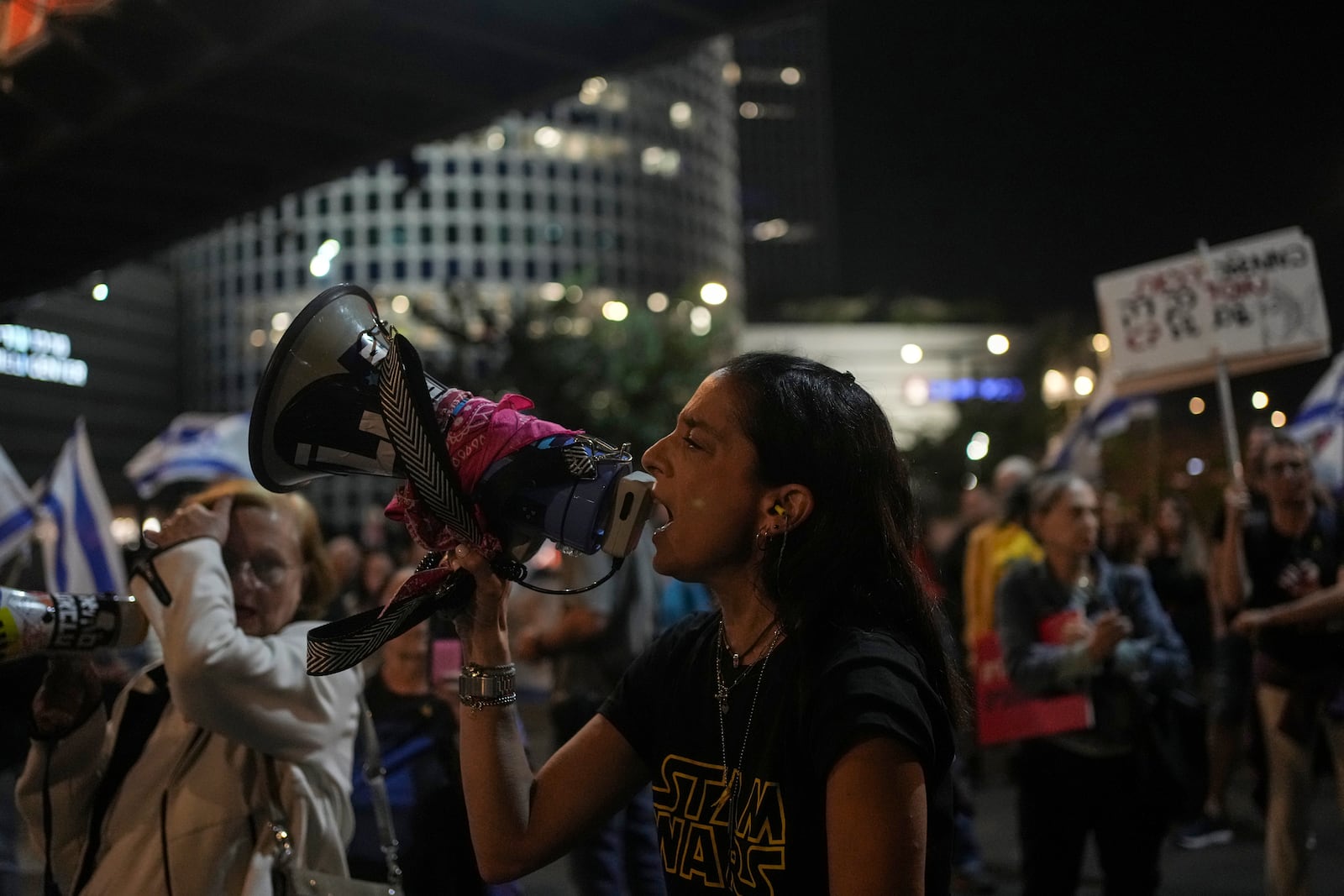 A woman shouts slogans during a protest against Prime Minister Benjamin Netanyahu's government and call for the release of hostages held in the Gaza Strip by the Hamas militant group, in Tel Aviv, Israel, Saturday, Nov. 23, 2024. (AP Photo/Maya Alleruzzo)