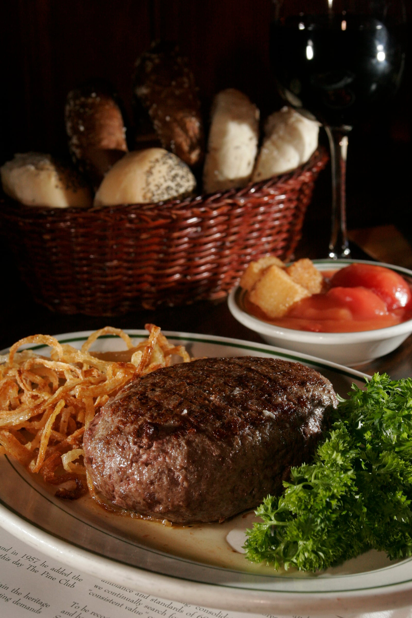 The Pine Club famous steak, rolls and stewed tomatoes