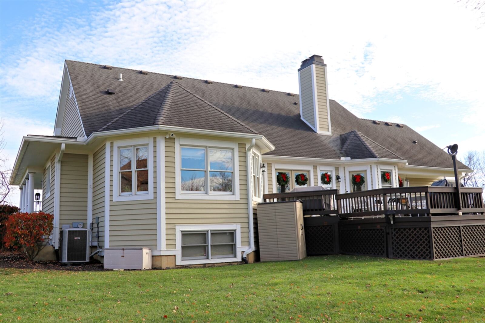 At the back, an extensive deck with accent lights continues to an outdoor entertainment space.