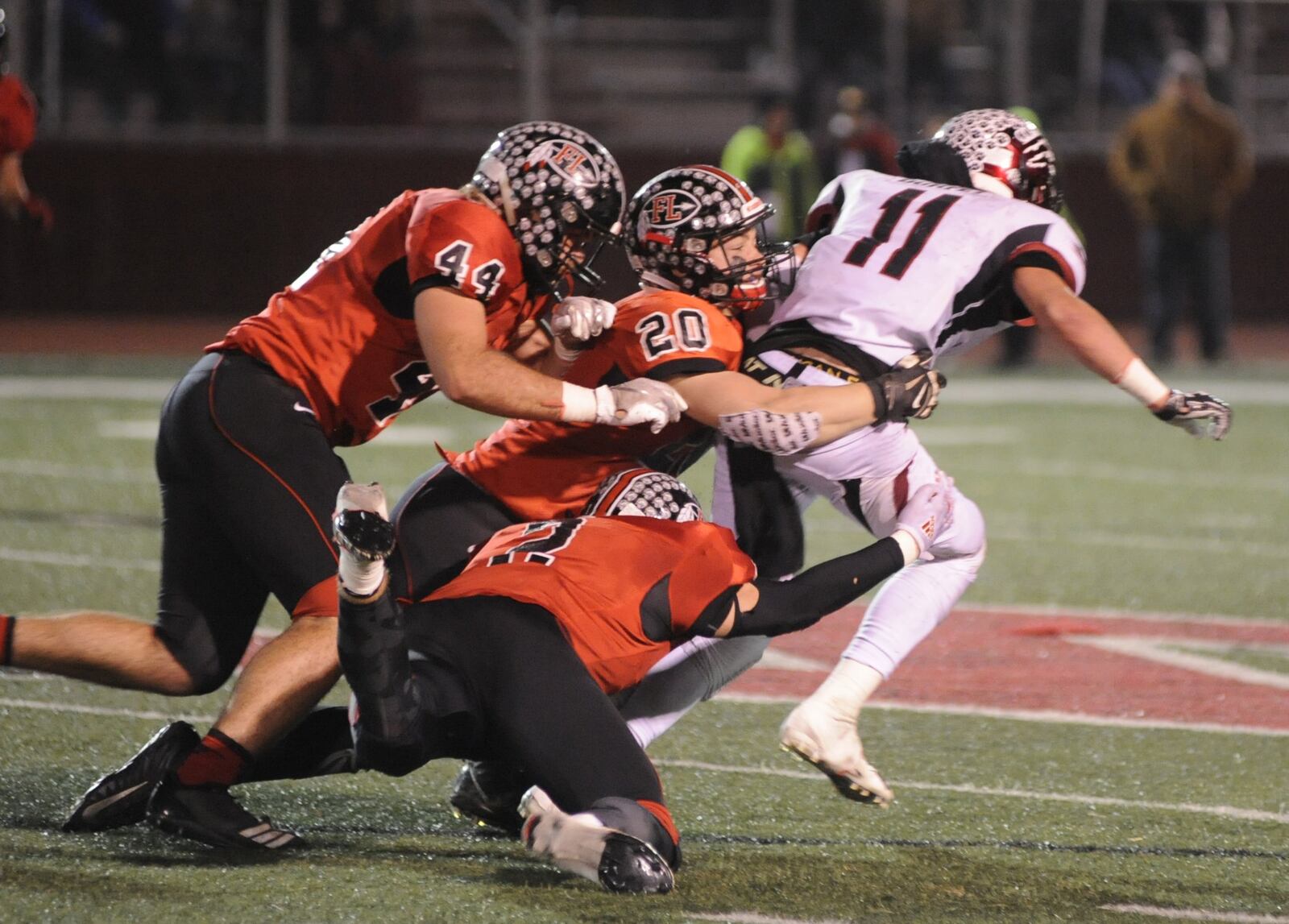 Fort Loramie’s CJ Billing (44), Max Hoying (20) and Devin Wehrman (bottom) take down McComb’s Tyler Durfey. McComb defeated Fort Loramie 28-14 in a D-VII high school football state semifinal at Wapakoneta on Saturday, Nov. 24, 2018. MARC PENDLETON / STAFF