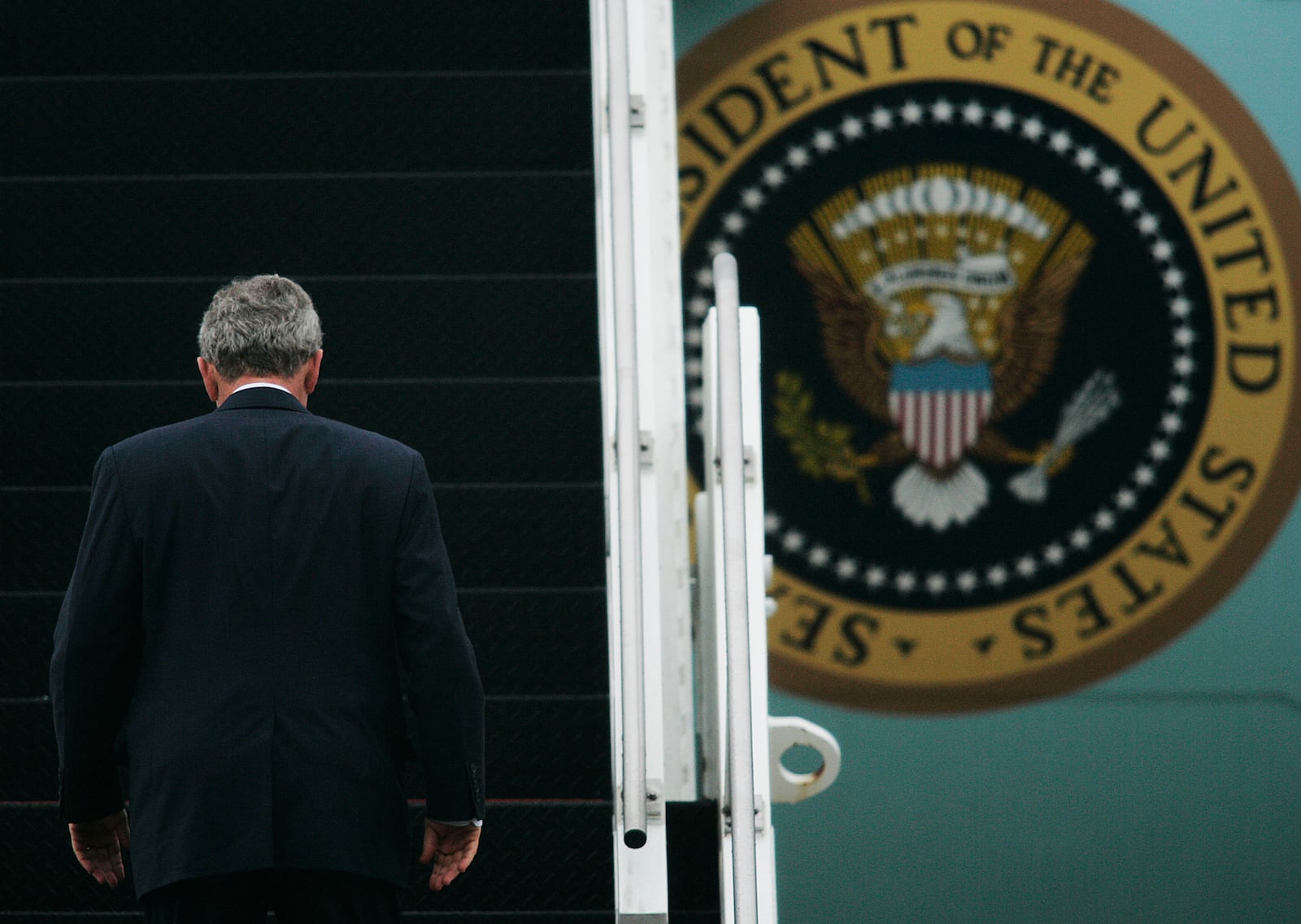 President Bush climbs the stairs of Air Force One in this 2008 file photo after delivering a speech at the Air Force Museum. Jim Noelker/Dayton Daily News