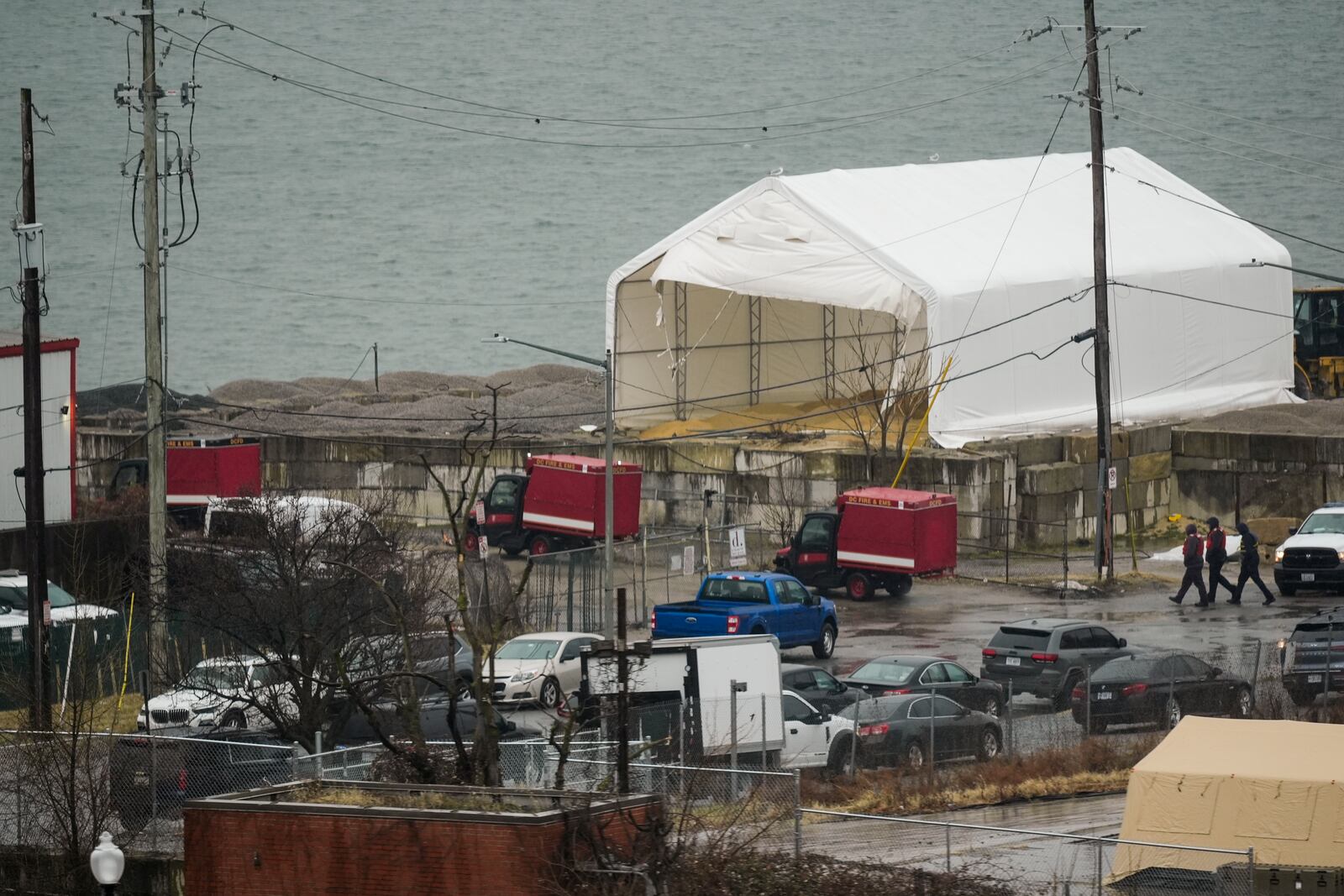 Emergency vehicles and recovery operations are seen near the mouth of the Anacostia River at the Potomac River near Ronald Reagan Washington National Airport, Friday, Jan. 31, 2025, in Washington. (AP Photo/Carolyn Kaster)