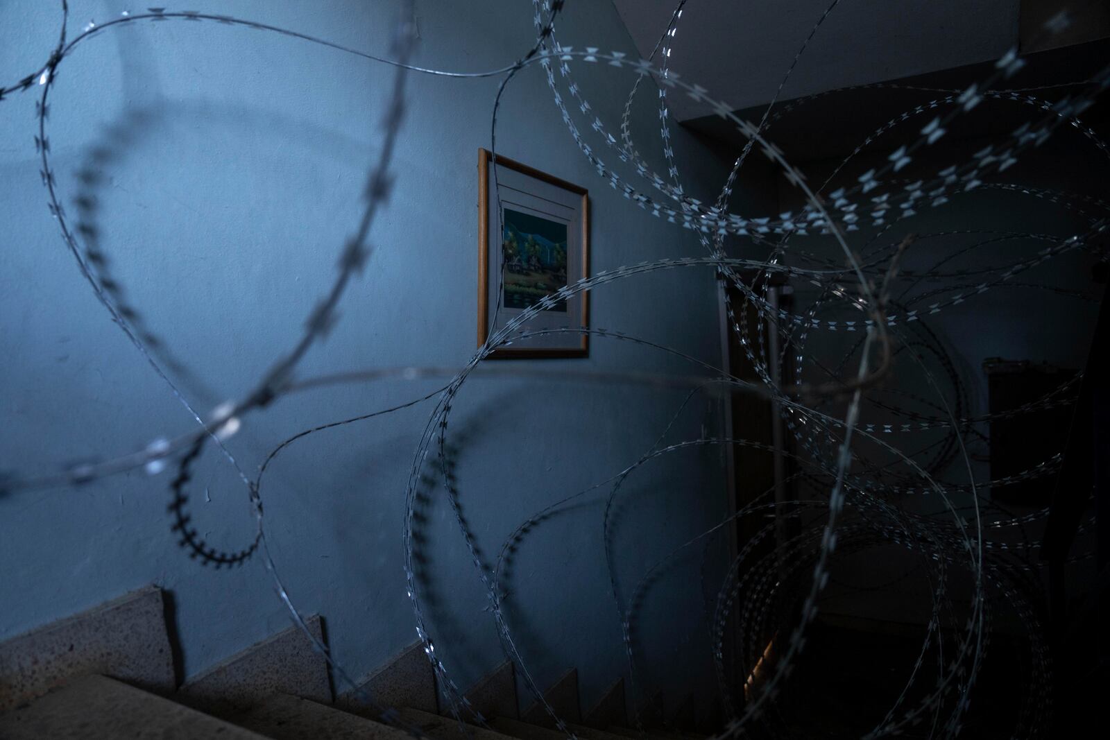 A stairwell in Kibbutz Manara, a community badly damaged by Hezbollah is lined with a barbed-wire fence in northern Israel, Monday Dec, 2, 2024. (AP Photo/Ohad Zwigenberg)