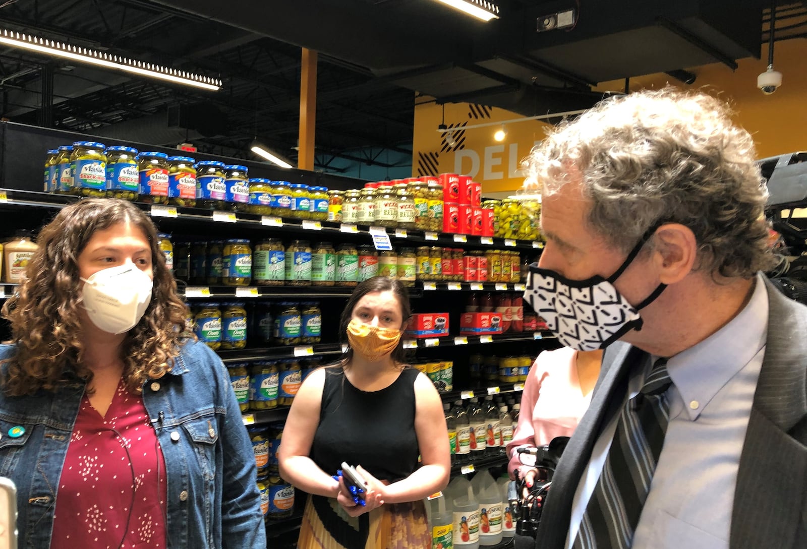 Sen. Sherrod Brown (D-Ohio) speaks with Lela Klein during a tour of the Gem City Market on Friday. Klein is on the market's board. CORNELIUS FROLIK / STAFF