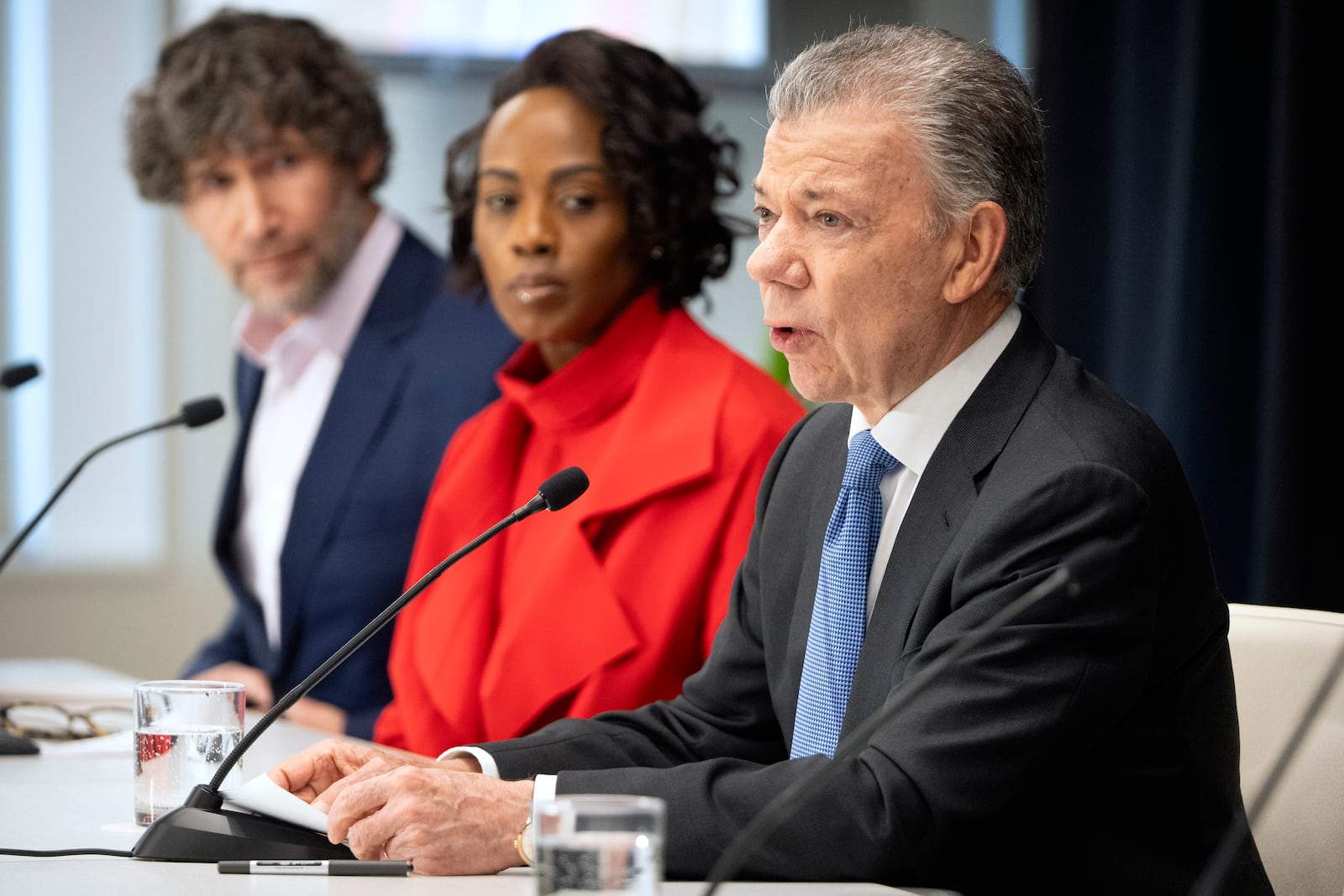 Former Colombian President Juan Manuel Santos, right, speaks as Bulletin of the Atomic Scientists members Daniel Holz, left, and Suzet McKinney listen during a news conference to announce the latest adjustment to the Doomsday Clock of the Bulletin of the Atomic Scientists, currently set at 89 seconds to midnight, at the United States Institute of Peace, Tuesday, Jan. 28, 2025, in Washington. (AP Photo/Mark Schiefelbein)