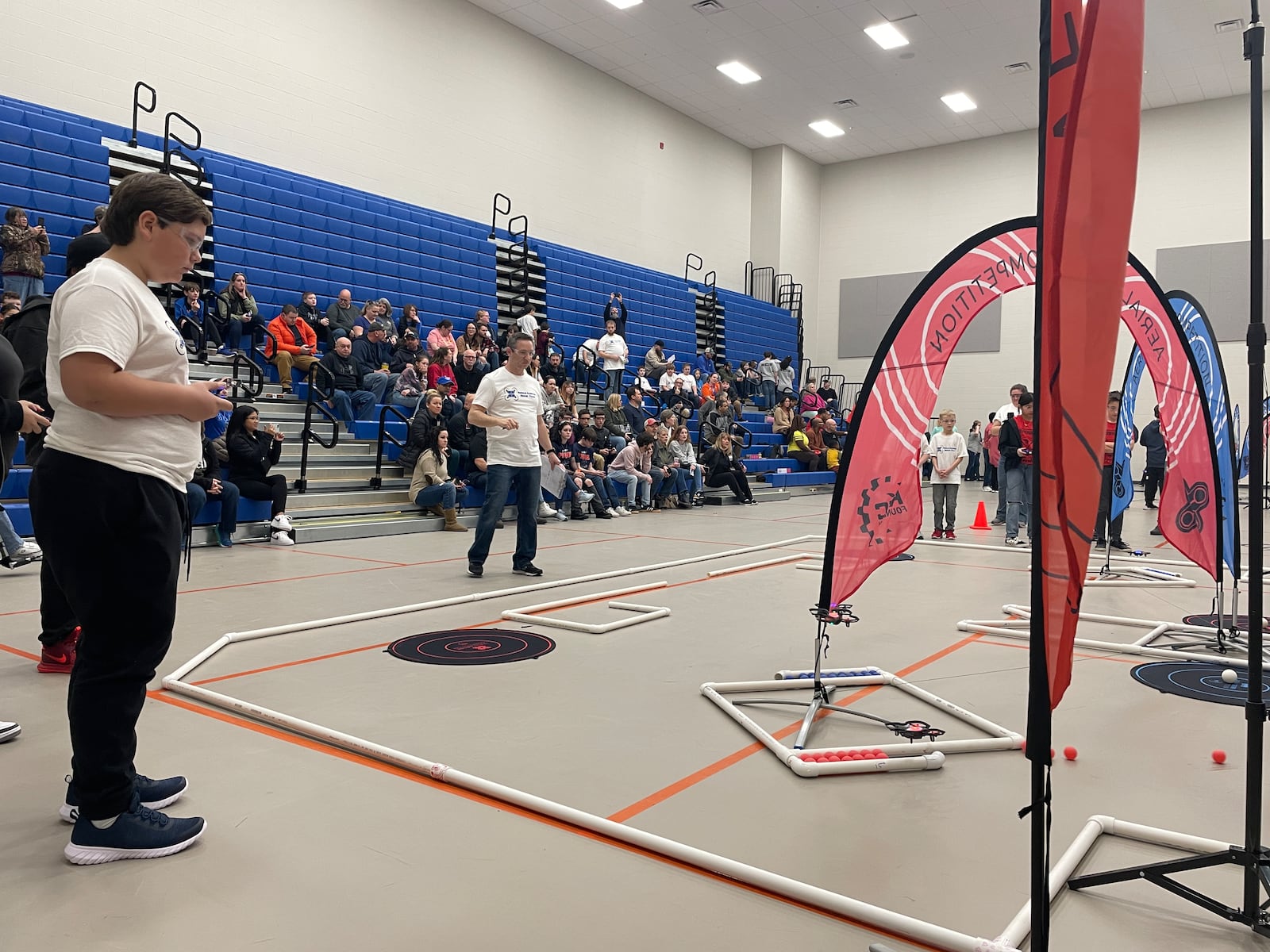 Mason Dameron (left), of Xenia, operates a drone during Saturday's aerial drone competition at the Greene County Career Center. SAMANTHA WILDOW\STAFF