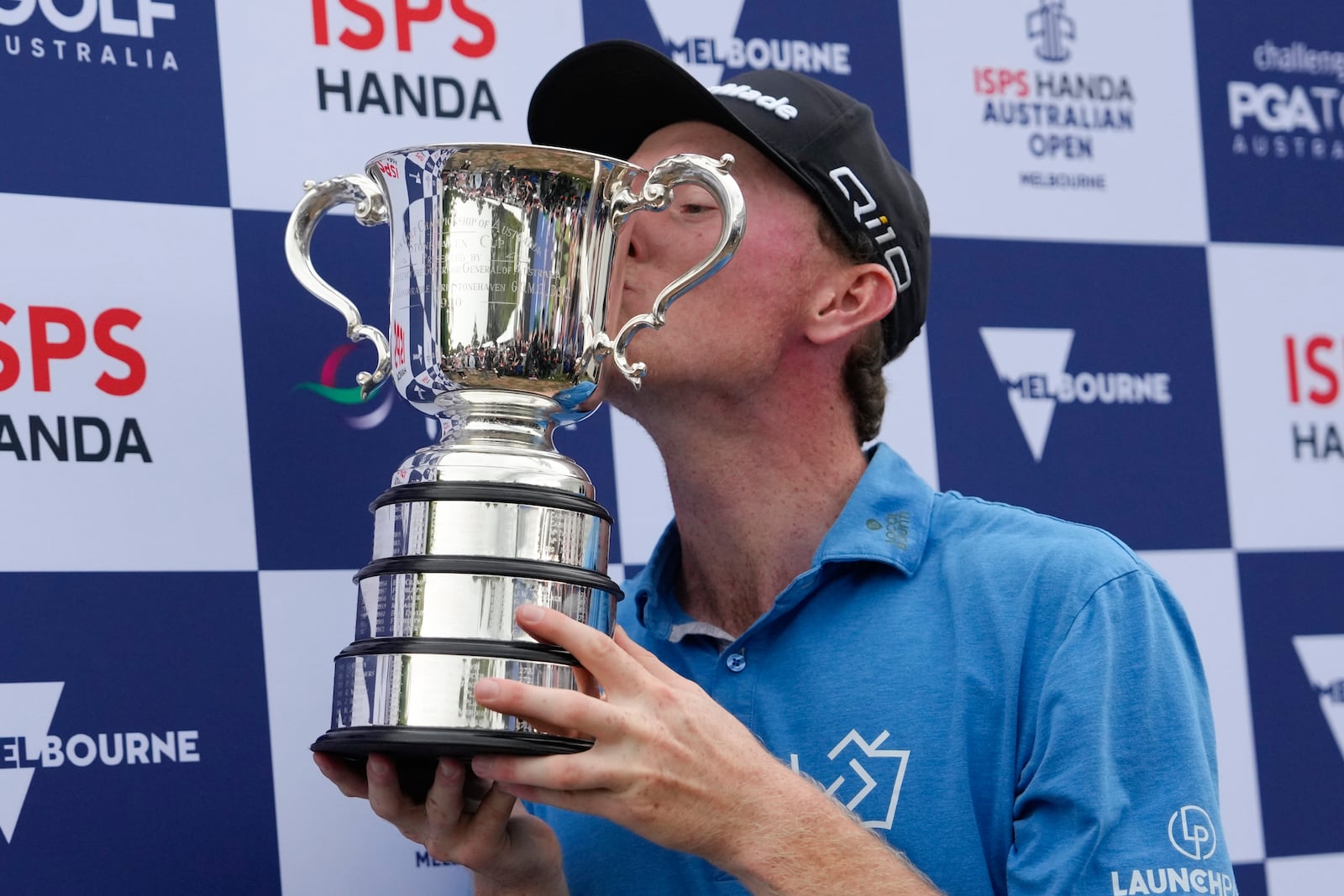 Ryggs Johnston of the United States kisses the Stonehaven Cup after winning the Australian Open golf championship at the Kingston Heath Golf Club in Melbourne, Australia, Sunday, Dec. 1, 2024. (AP Photo/Asanka Brendon Ratnayake)