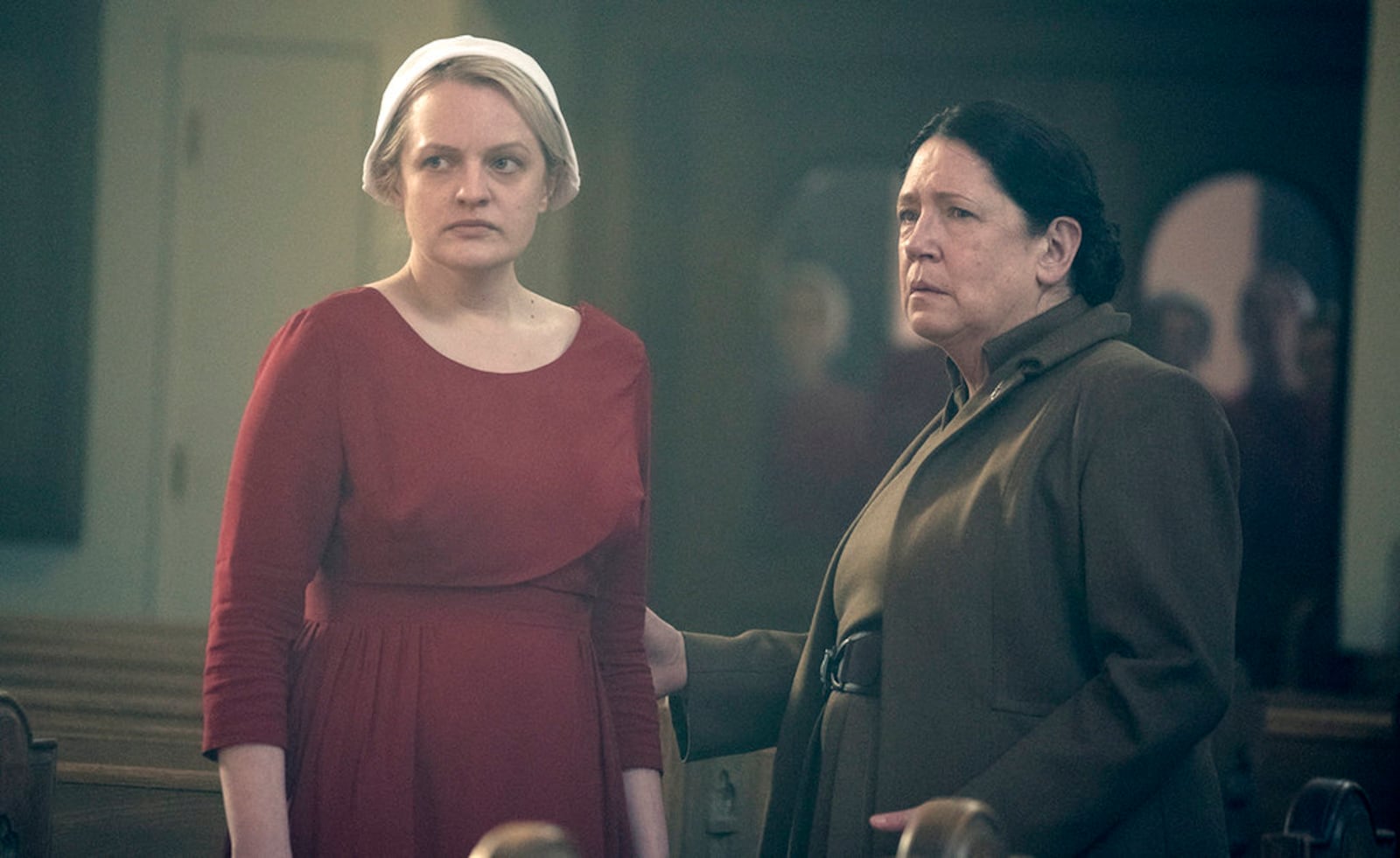 This image released by Hulu shows Elisabeth Moss, left, and Ann Dowd in a scene from "The Handmaid's Tale." The program was nominated for an Emmy on Thursday for outstanding drama series. The 70th Emmy Awards will be held on Monday, Sept. 17. (George Kraychyk/Hulu via AP)