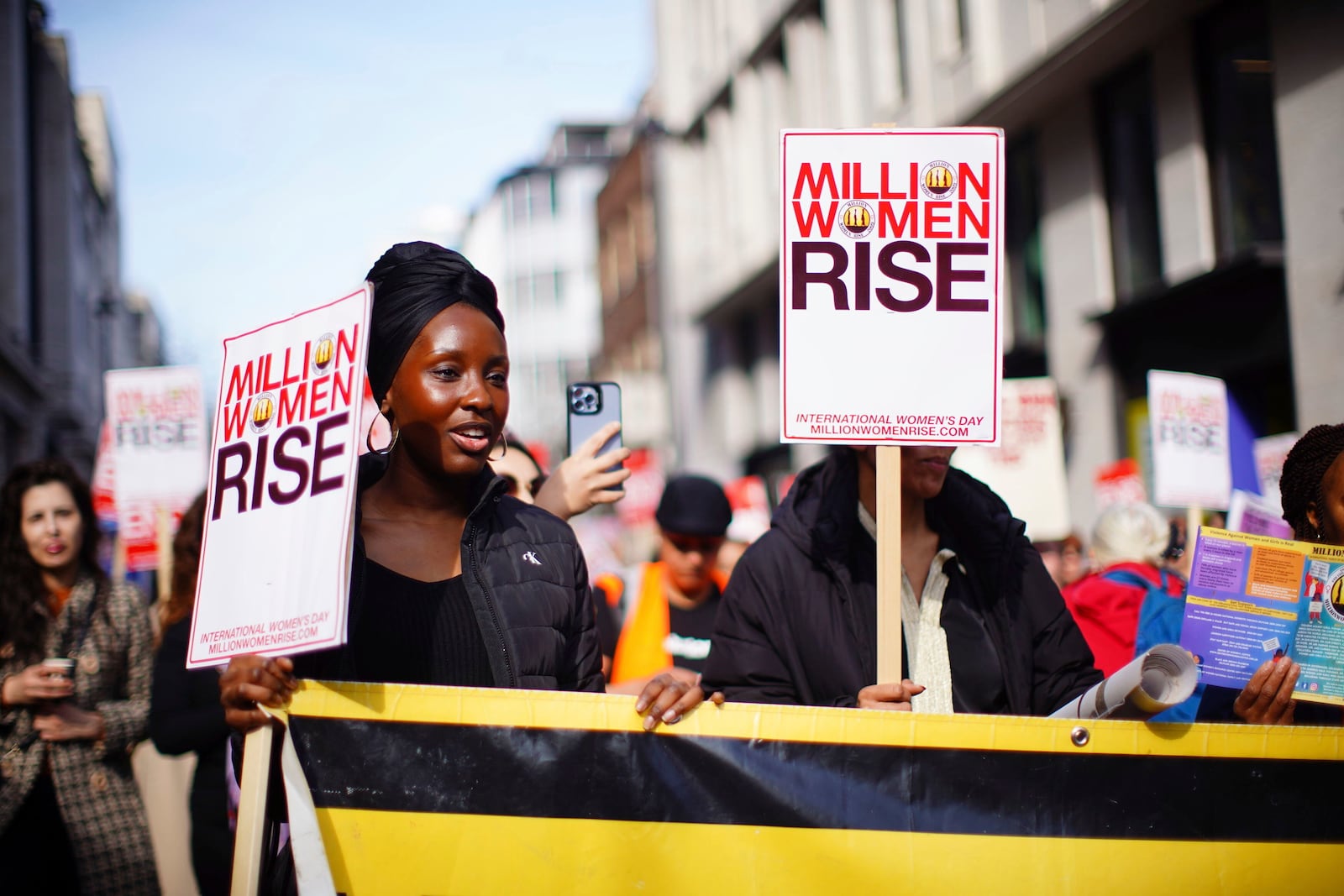 People take part in the 18th annual Million Women Rise march on International Women's Day, in central London, Saturday March 8, 2025. (James Manning/PA via AP)