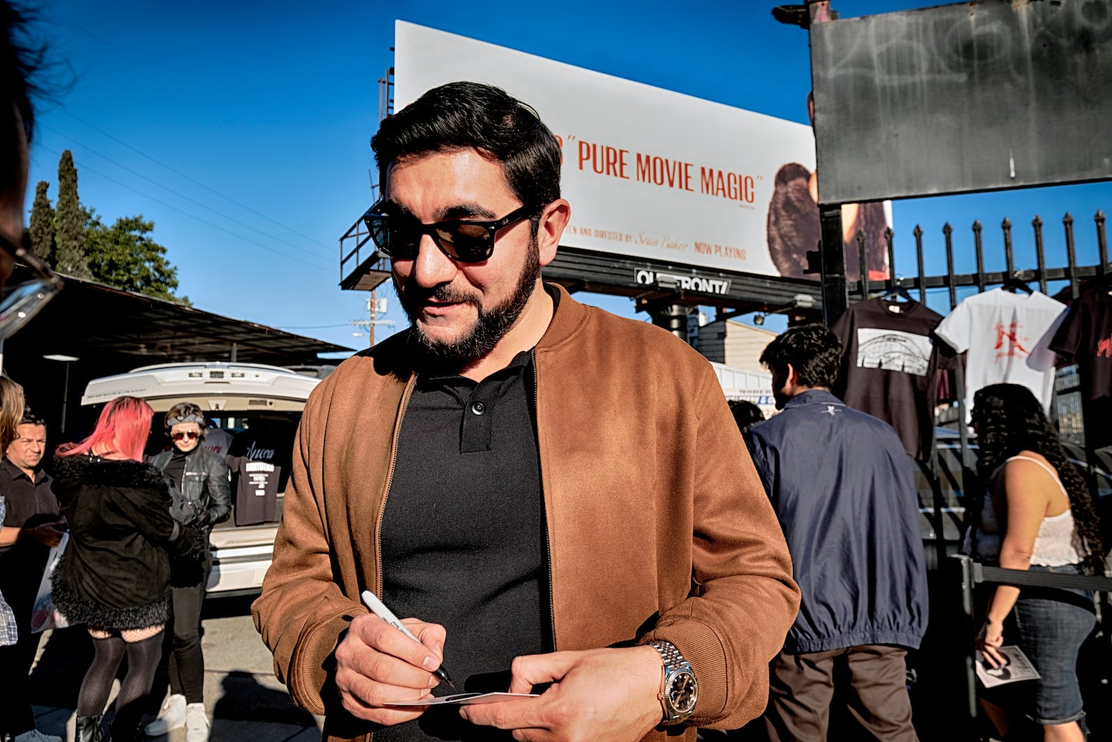 Actor Vache Tovmasyan signs an autograph for a fans during a merchandise Pop-Up event for the newly released film, Anora on Saturday, Nov. 9, 2024 in Los Angeles. (AP Photo/Richard Vogel)