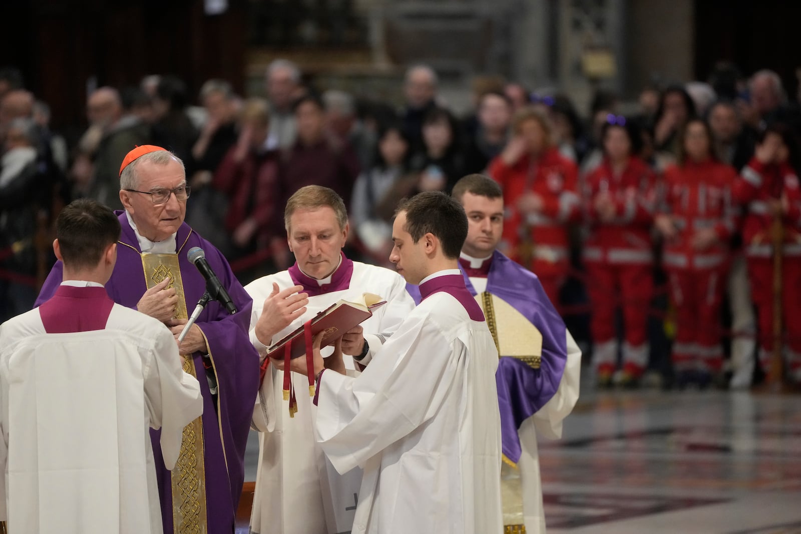 Vatican Secretary of State, Cardinal Pietro Parolin, left, delegated by Pope Francis who's being treated for pneumonia at Rome's Agostino Gemelli Polyclinic, presides over a mass with the pilgrims of the "Movement for Life" in St. Peter's Basilica at The vatican, Saturday, March 8, 2025. (AP Photo/Gregorio Borgia)