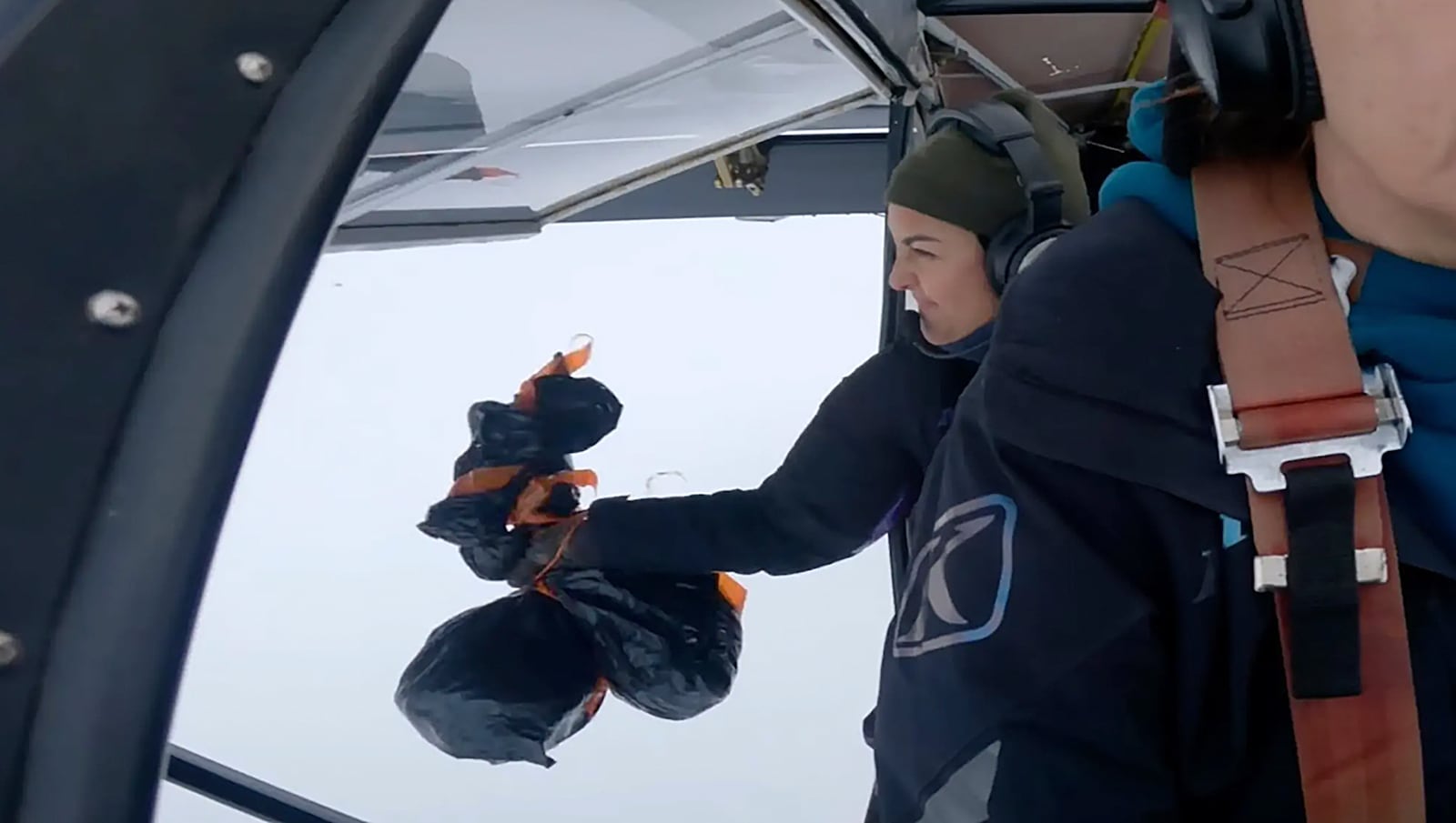 This undated image provided by Alaska Gear Company shows Esther Keim dropping frozen turkeys to residents in rural Alaska. (Alaska Gear Company via AP)