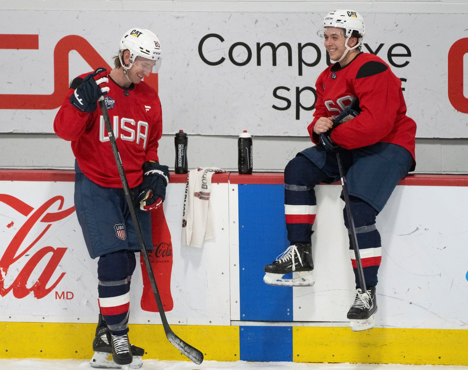 U.S. players Jake Sanderson, left and Brock Faber talk during a 4 Nations Face-Off hockey practice in Brossard, Que., on Monday, Feb. 10, 2025. (Christinne Muschi/The Canadian Press via AP)