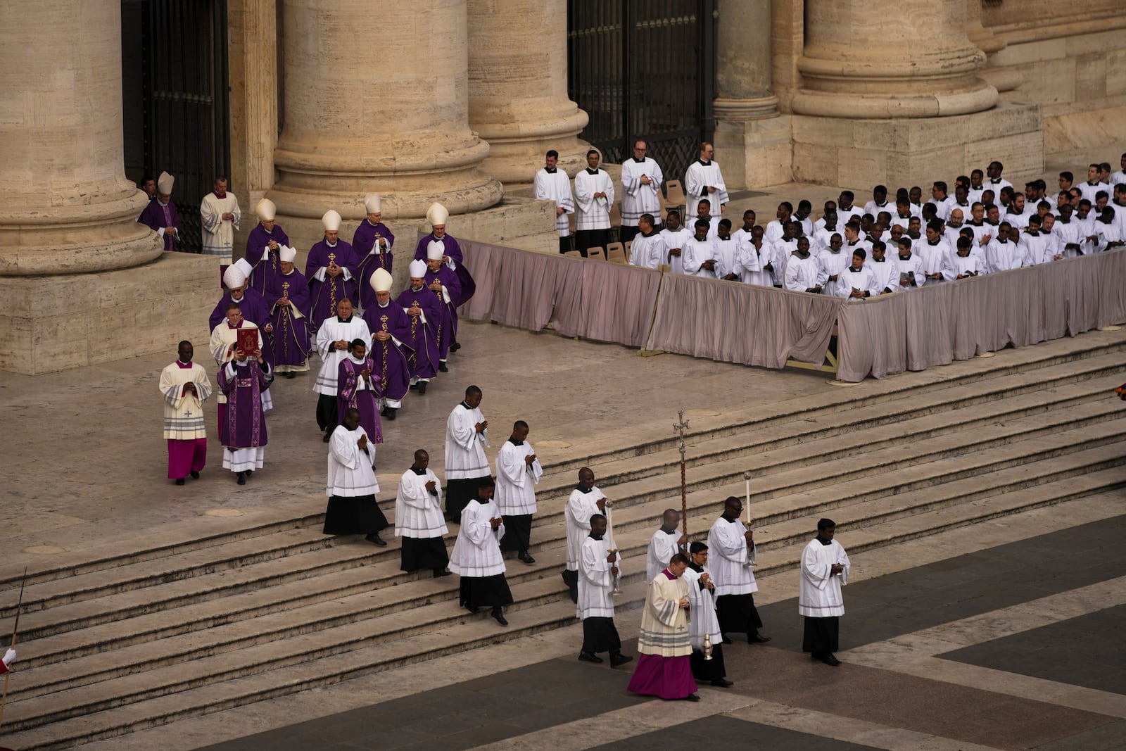 Cardinal Michael Czerny, left, delegate of Pope Francis who is being treated for pneumonia at Rome's Agostino Gemelli Polyclinic, arrives to celebrate a mass for the members of the world of volunteers in St. Peter's Square at The Vatican, Sunday, March 9, 2025. (AP Photo/Francisco Seco)