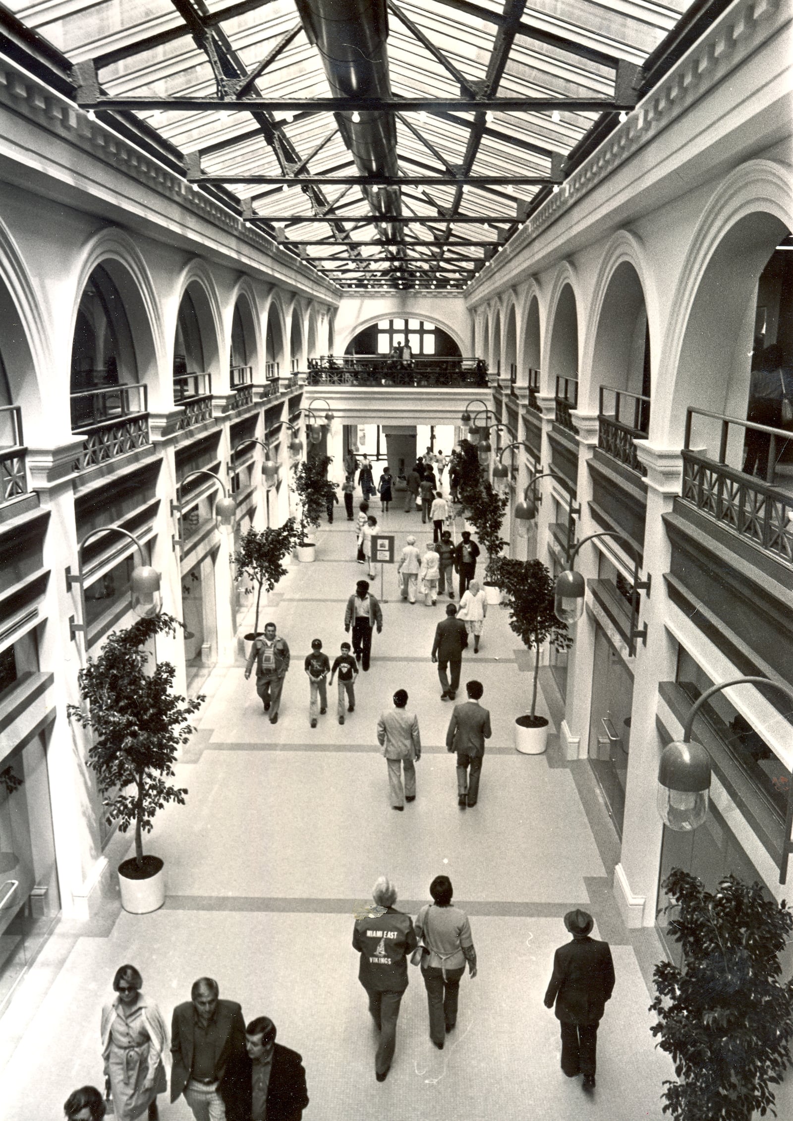 A 200-foot-long glass roofed corridor led visitors from the main entrance of the Dayton Arcade on Third Street to the glass roofed rotunda centerpiece. Visitors stroll along the walkway in this 1980 photograph. DAYTON DAILY NEWS ARCHIVE