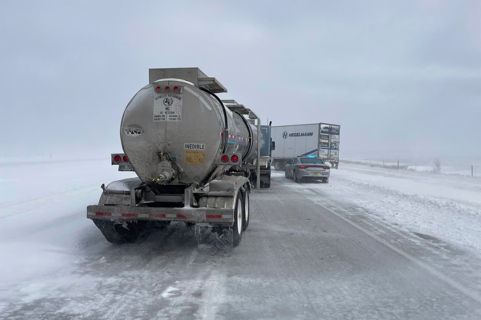 In this photo provided by the Iowa State Patrol, a jackknifed semi truck blocks both eastbound lanes on U.S. 20 east of Fort Dodge, Iowa, on Wednesday, March 5, 2025. (Trooper Paul Gardner/Iowa State Patrol via AP)