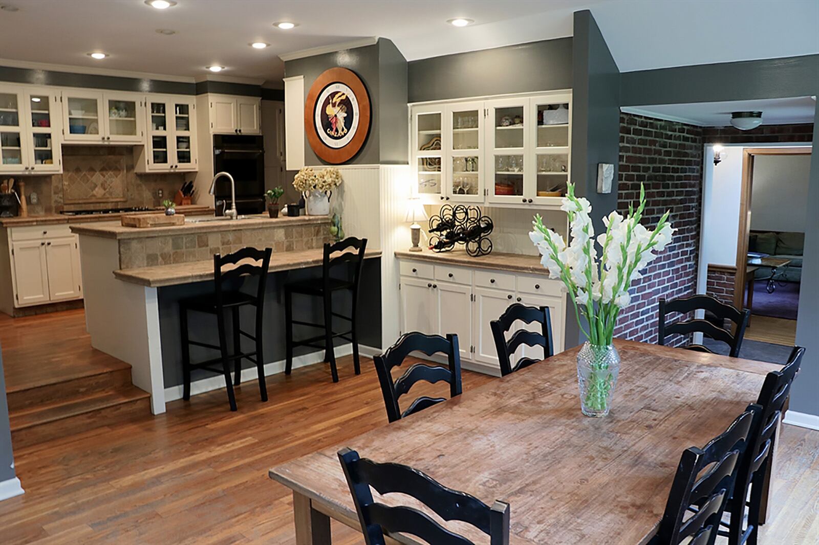 The galley kitchen has Italian tumble marble countertops one of which is a two-level peninsula with breakfast bar seating within the sun-filled breakfast room. The kitchen has antique white cabinetry and stainless-steel appliances, including a five-burner cooktop and double wall ovens. CONTRIBUTED PHOTO BY KATHY TYLER