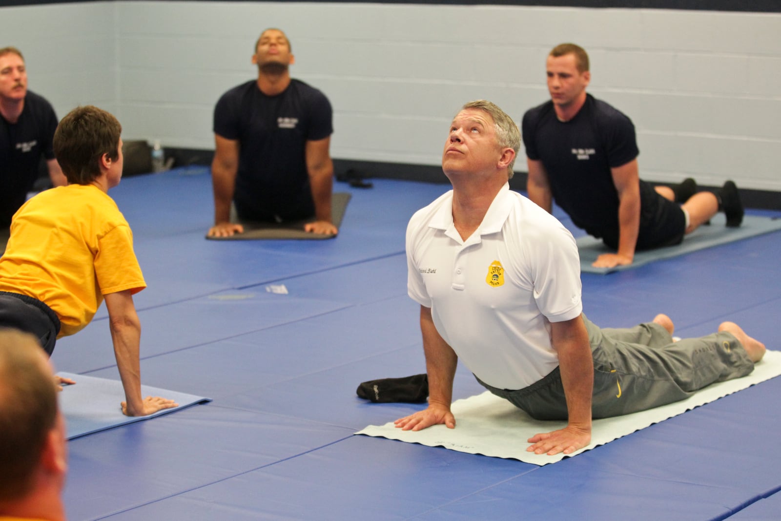 Dayton Police Chief Richard S. Biehl teaches yoga to police recruits at the Dayton Police Academy as an alternative treatment to PTSD. Staff photo by Jim Witmer