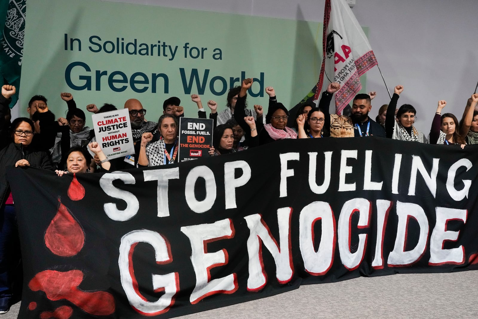 Activists demonstrate for climate justice and a ceasefire in the Israel-Hamas at the COP29 U.N. Climate Summit, Monday, Nov. 11, 2024, in Baku, Azerbaijan. (AP Photo/Rafiq Maqbool)