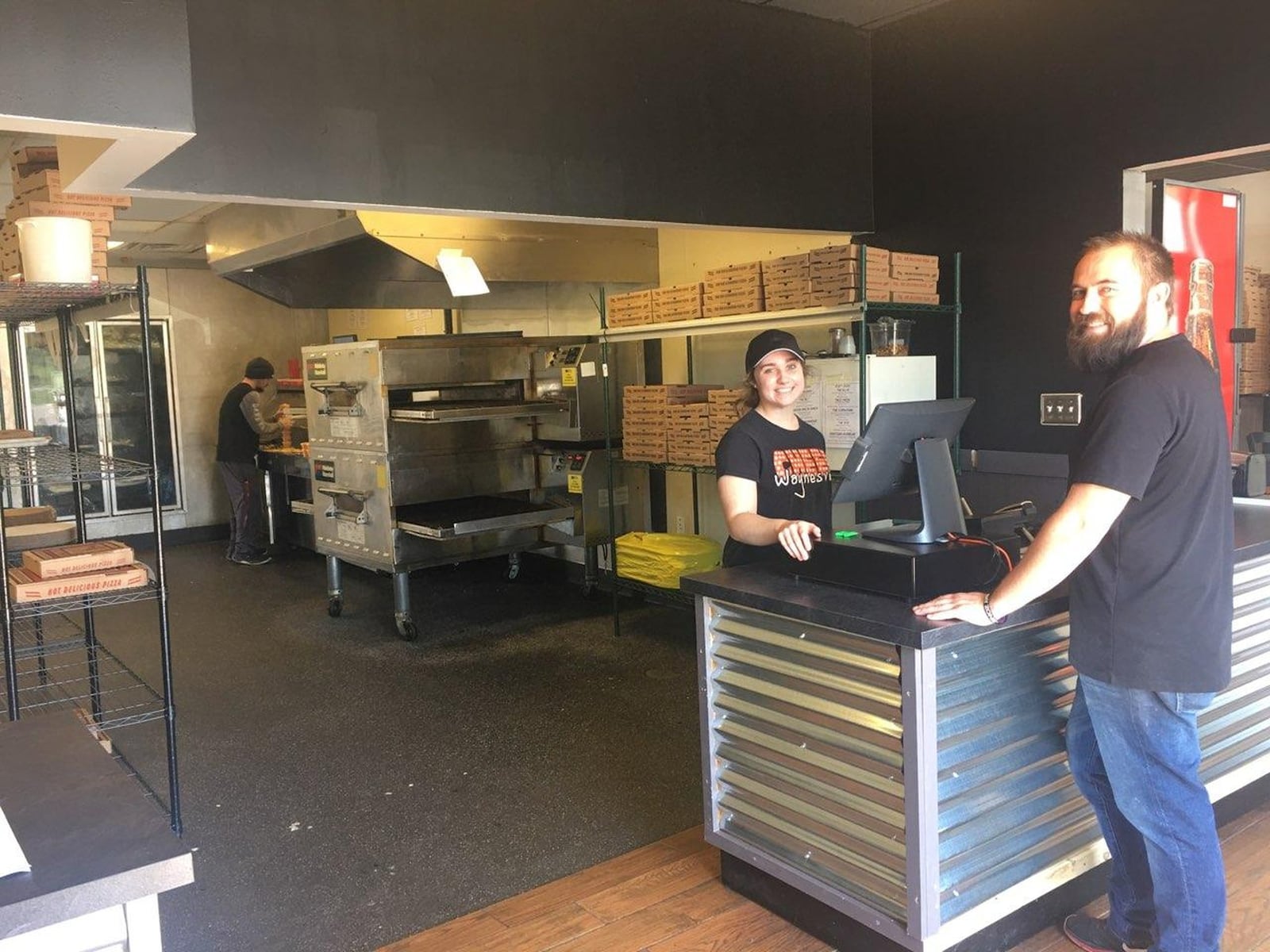 Madison Lowe waits on customer Eric Meador Monday at Roscoe’s Pizza.