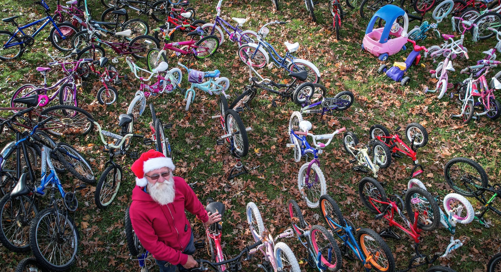 David Nugent, 81, from Brookville collects, fixes and gives away hundreds of bikes to kids at Christmas. "I lost my wife, my girlfriend and my dog all I got left are the kids, Nugent said. JIM NOELKER/STAFF