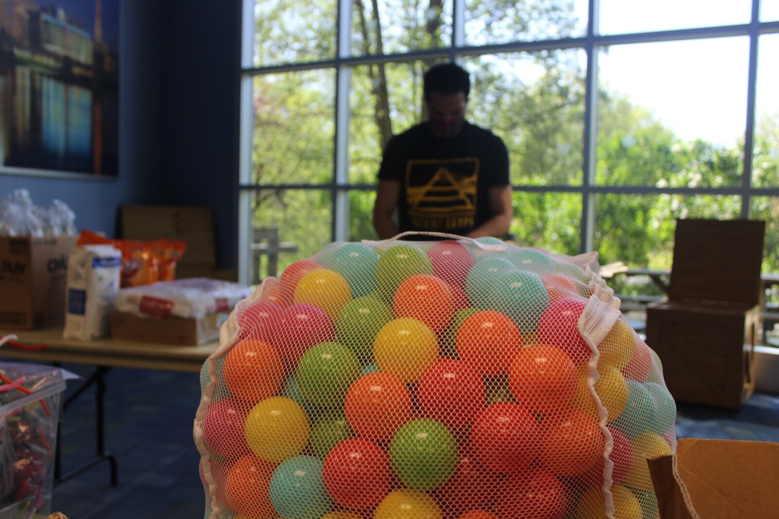 The Boonshoft Museum of Discovery closed to the public on May 15.  Bryan Smith, a coordinator,  helps assemble Camp in a Box kits.