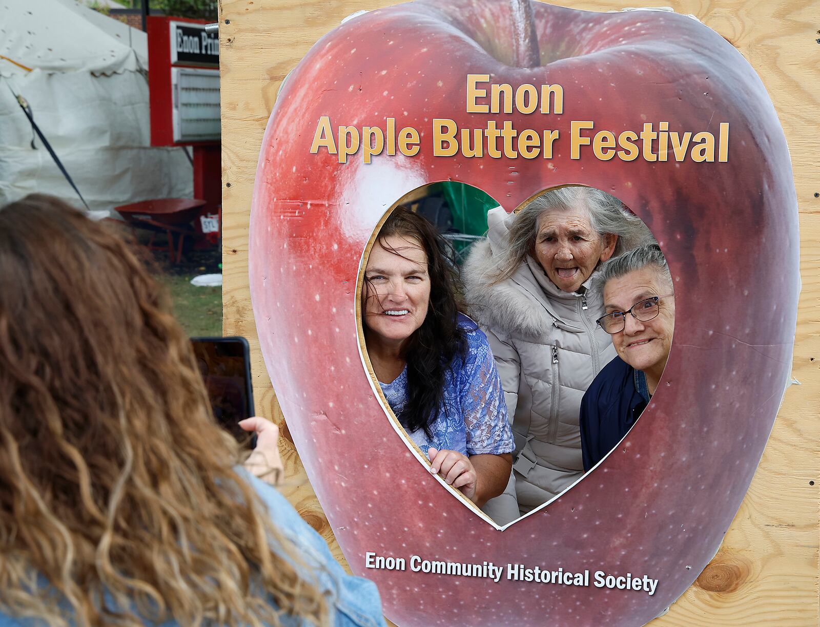 A family poses for a picture during the 2023 Enon Apple Butter Festival. BILL LACKEY/STAFF