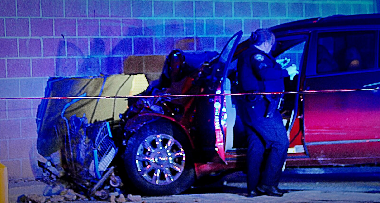 Miami Twp. Sgt. Julie Fiebig investigates after a red SUV crashes into Walmart on Kingsridge Drive.