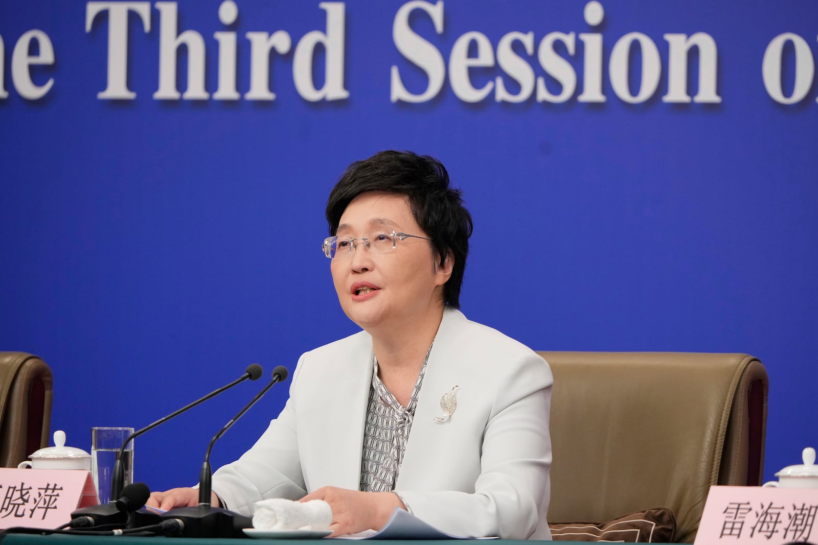 Wang Xiaoping, minister of Human Resources and Social Security speaks during a press conference for the second session on the sideline of the National People's Congress in Beijing, China, Sunday, March 9, 2025. (AP Photo/Vincent Thian)